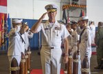 SOUTH CHINA SEA (Sept. 29, 2019) Rear Adm. George M. Wikoff commander, Task Force (CTF) 70, salutes sideboys as he departs a change of command ceremony in the hangar bay of the aircraft carrier USS Ronald Reagan (CVN 76). CTF 70 is forward deployed to the U.S 7th Fleet area of operations in support of security and stability in the Indo-Pacific region.