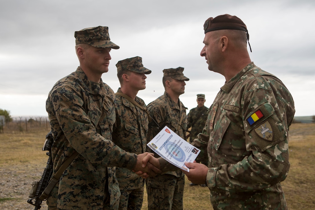 U.S. Marines with Marine Rotational Force-Europe 19.2, Marine Forces Europe and Africa, receive certificates from a Romanian soldier with the 341st Infantry Battalion during the exercise Platinum Eagle closing ceremony in Babadag Training Area, Romania, Sept. 19, 2019.