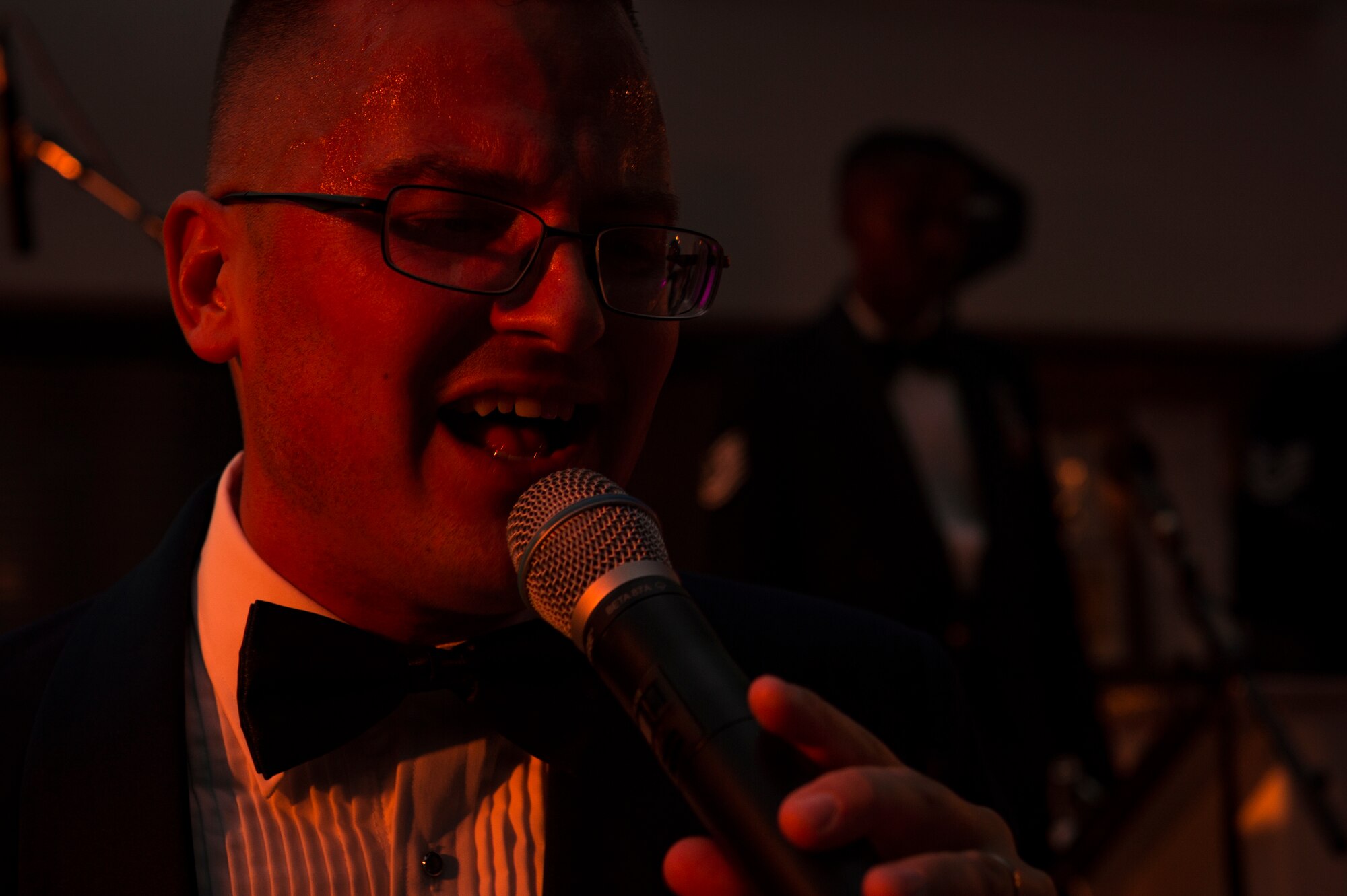 U.S. Air Force Staff Sgt. Nicholas Del Villano, U.S. Air Forces in Europe band member, sings during the 72nd Air Force birthday ball at Ramstein Air Base, Germany, Sept. 21, 2019. Del Villano performed with the USAFE Jazz and Rock bands, playing two sets of music, a jazz set during the dinner portion of the evening and a dance set after the formal portion of the evening. (U.S. Air Force photo by Staff Sgt. Jonathan Bass)