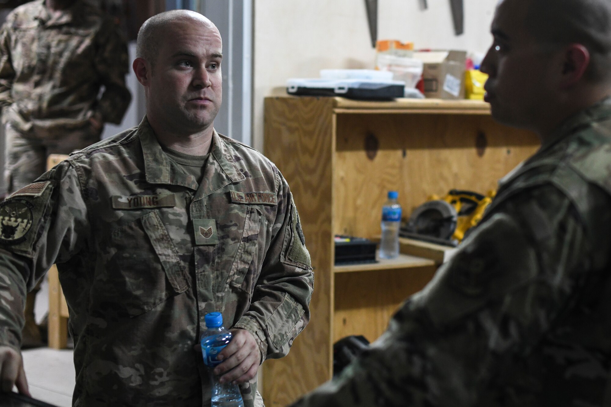 Staff Sgt. Tyler Young, 386th Expeditionary Civil Engineer Squadron material control craftsman, talks with his NCO-in-charge, Master Sgt. Brian Encarnacion, at the U-Fix-It shop at Ali Al Salem Air Base, Kuwait, Sept. 6, 2019. U-Fix-It is in chare of servicing customers that require items for areas such as power pro, electrical, heating, ventilation and air conditioning and more. (U.S. Air Force photo by Senior Airman Lane T. Plummer)