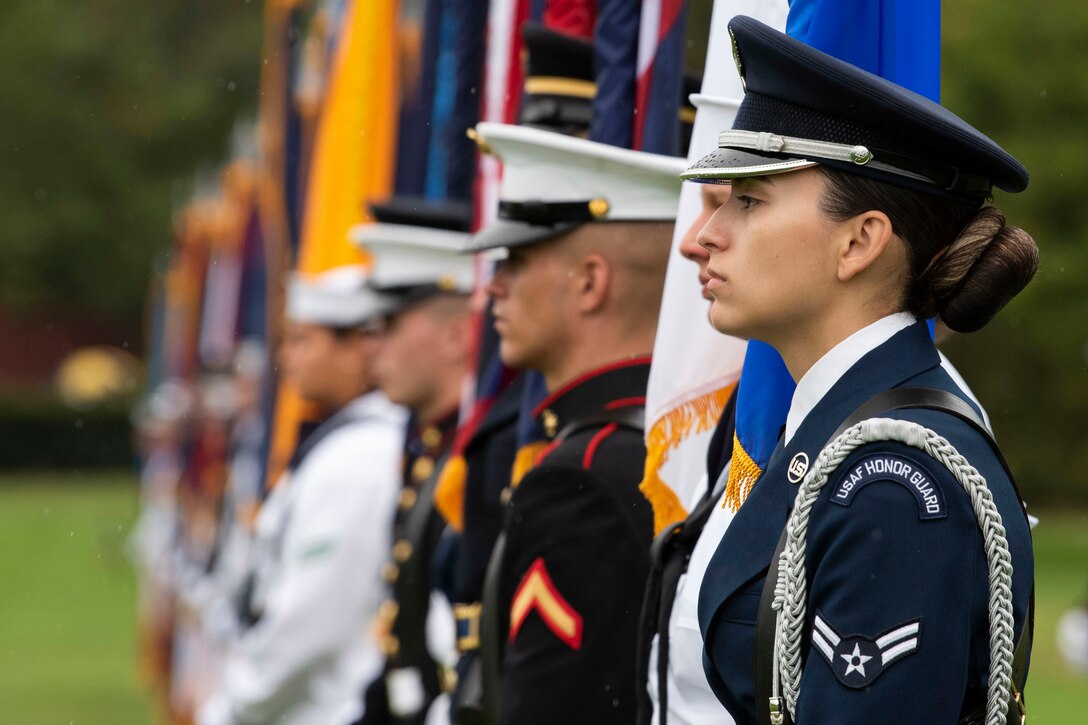 Members of an honor guard stand at attention.