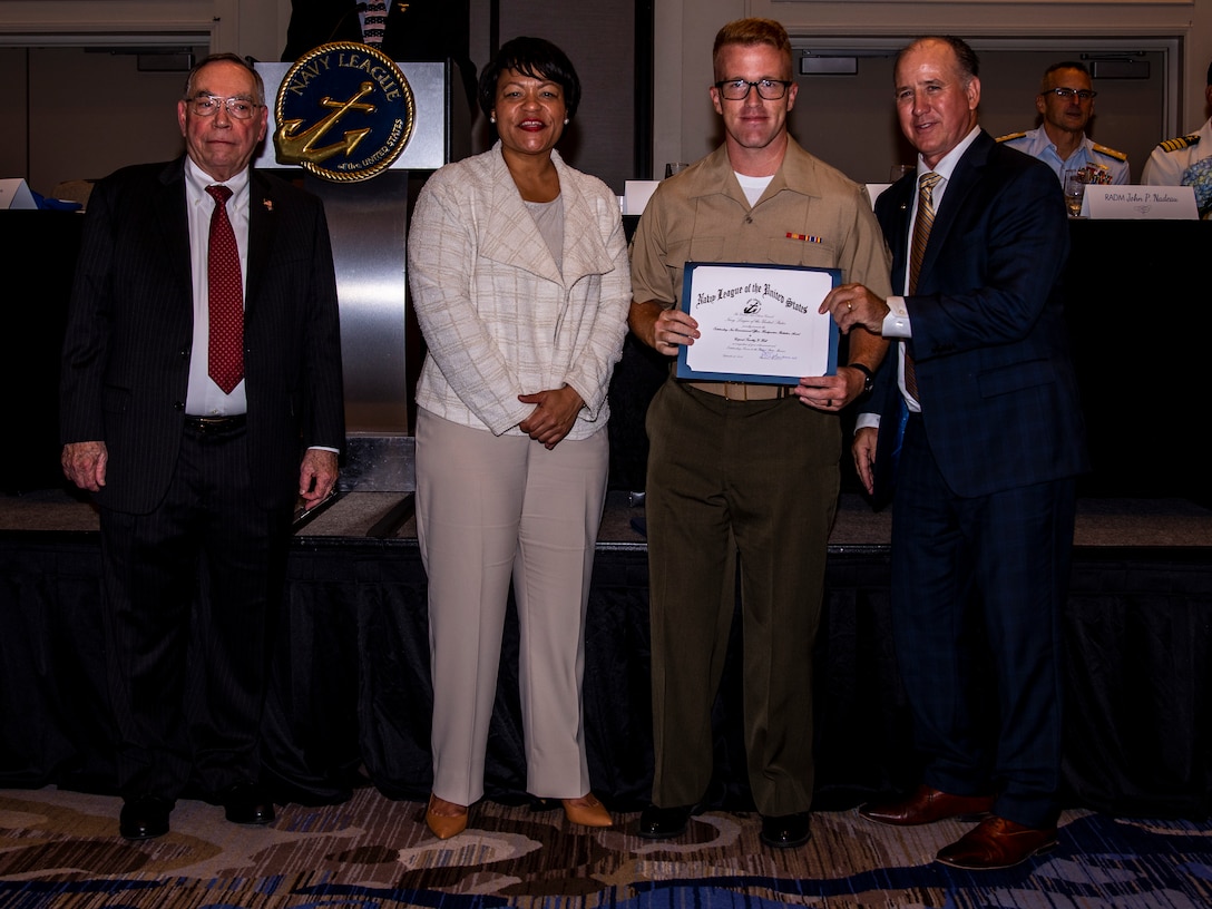 U.S. Marine Corps Cpl. Timothy Y. Hall, a data system administrator with Headquarters Battalion, Marine Forces Reserve, receives an award during the Navy League Military Appreciation Luncheon, New Orleans, Sept. 27, 2019. The Navy League awarded Hall for being the most outstanding noncommissioned officer of Headquarters Battalion, MARFORRES. (U.S. Marine Corps photo by Lance Cpl. Jose Gonzalez)