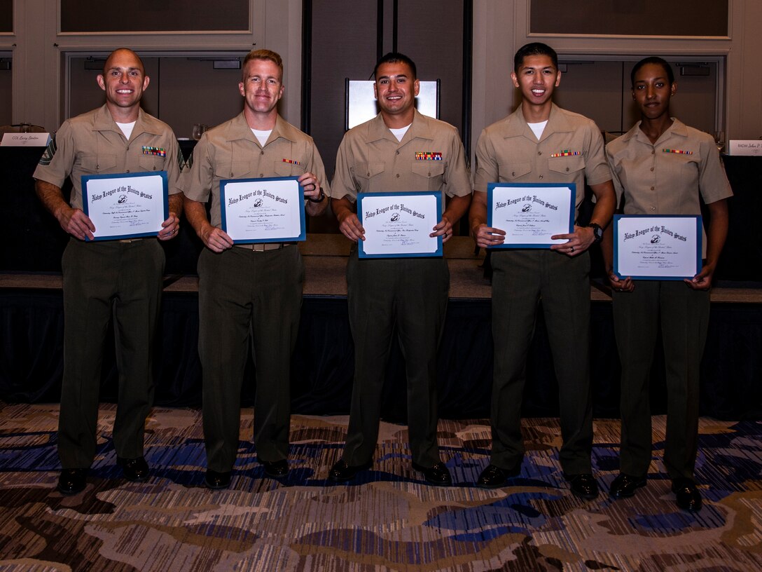 U.S. Marines with Marine Forces Reserve pose for a photo during the Navy League Military Appreciation Luncheon, New Orleans, Sept. 27, 2019. The Navy League awarded the Marines for being the most outstanding noncommissioned and staff NCO of their command. (U.S. Marine Corps photo by Lance Cpl. Jose Gonzalez)