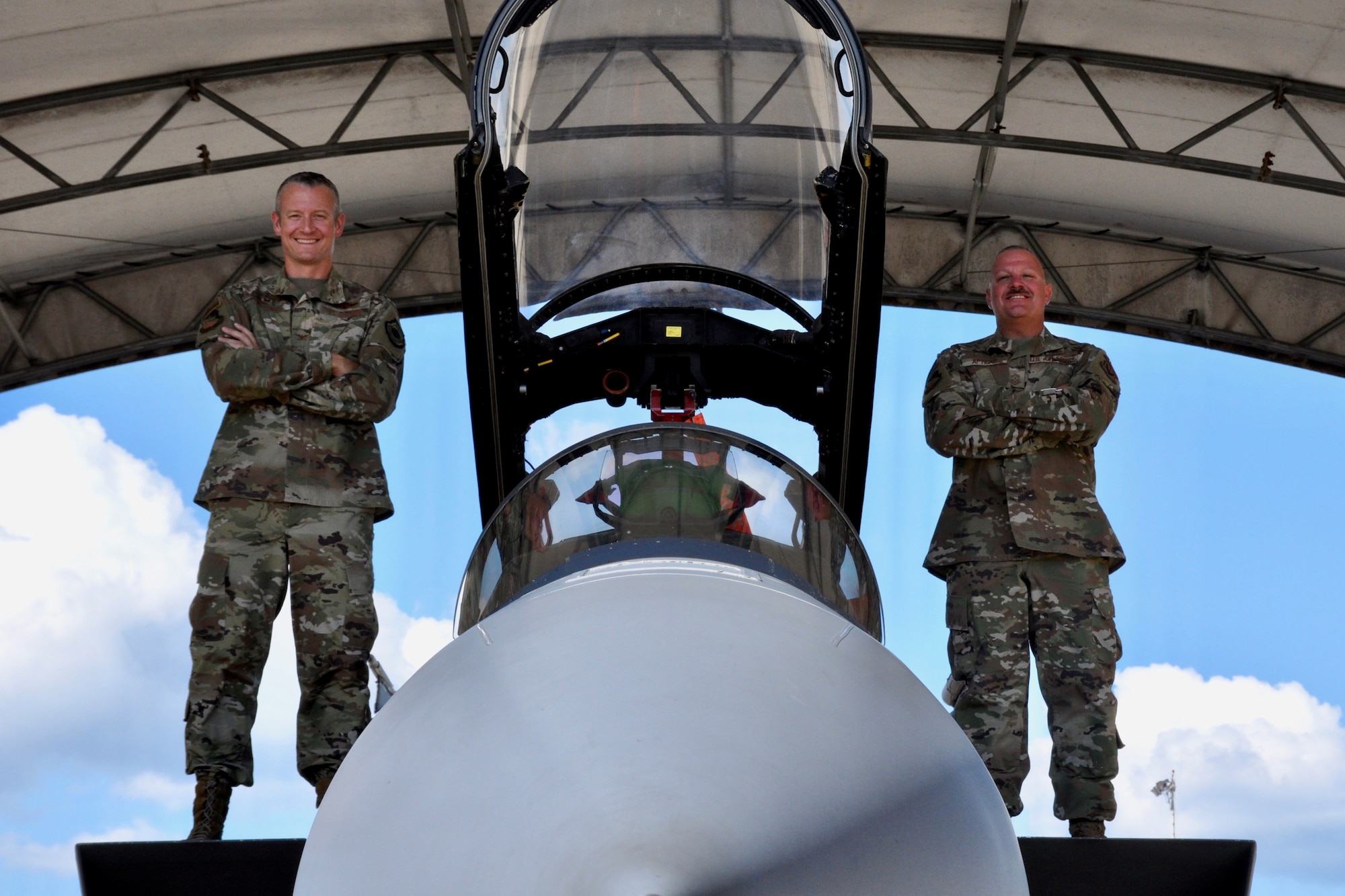 U.S. Air Force Col Ryan Messer, 53rd Wing Commander, and U.S. Air Force Chief Master Sgt. Justin Apticar, 53rd Wing Command Chief, pose on an F-15E Strike Eagle for a command team photo.