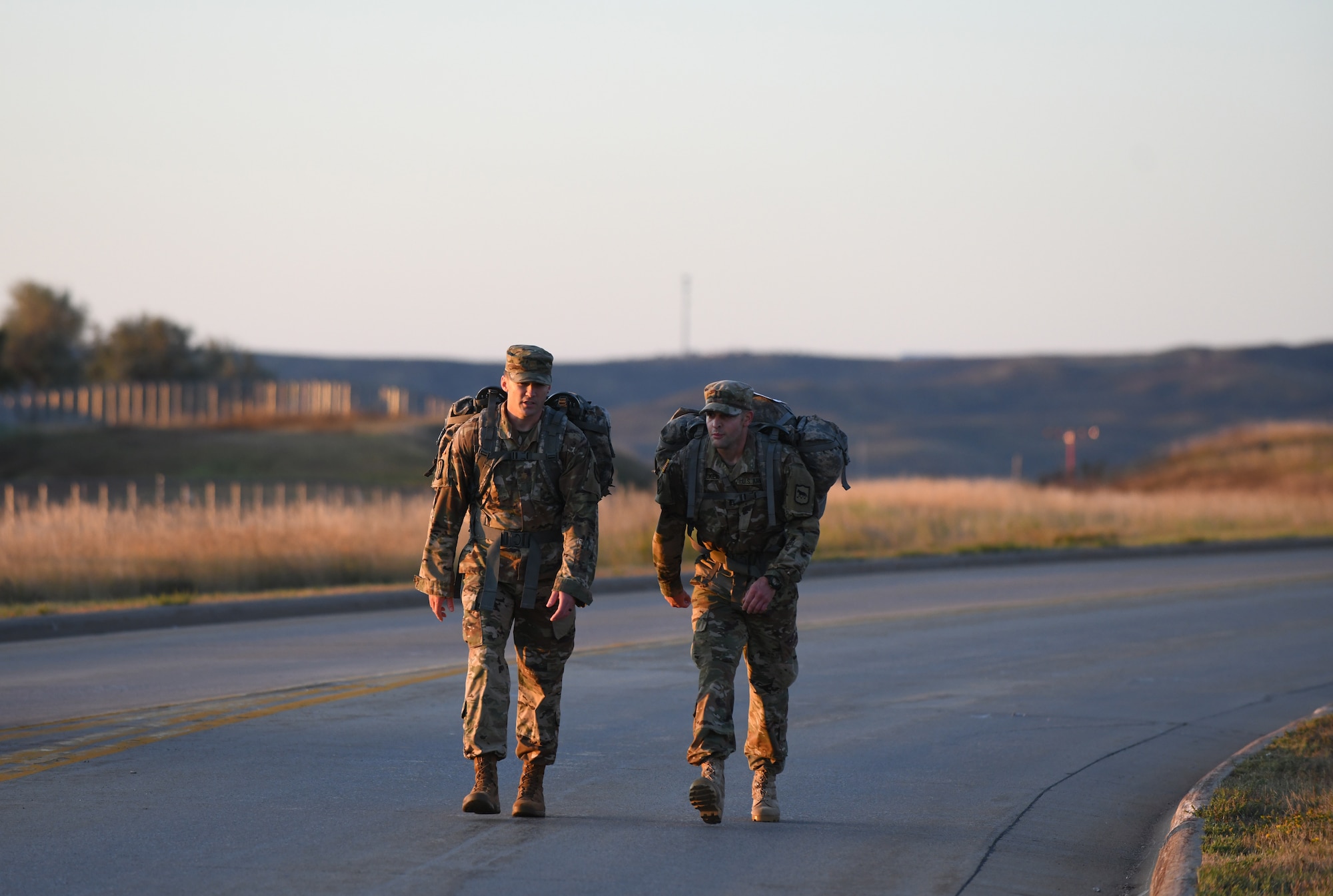 Airmen take part in a 7.46 mile ruck march on Ellsworth Air Force Base, S.D., Sept. 21, 2019. Eleven Ellsworth Airmen participated in the German Armed Forces Proficiency test alongside Army ROTC cadets and South Dakota Army National Guardsmen. Participants had to complete six events in order to qualify for the coveted German Armed Forces Proficiency Badge. (U.S. Air Force photo by Airman 1st Class Christina Bennett)