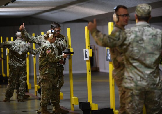 A group of German officers prepare targets for the pistol qualification portion of the German Armed Forces Proficiency Test at the Combat Arms and Maintenance facility at Ellsworth Air Force Base, S.D., Sept. 21, 2019. Participants had to complete six events comprised of a 100-meter swim in uniform, a chin up test, a 1,000-meter run, a sprint test, a pistol qualification test and a 7.46 mile ruck march. (U.S. Air Force photo by Airman 1st Class Christina Bennett)