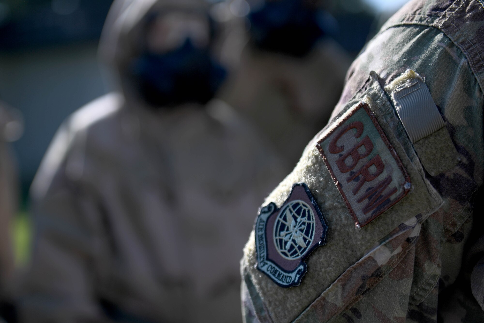 A CBRN patch is on the arm of an Airman.