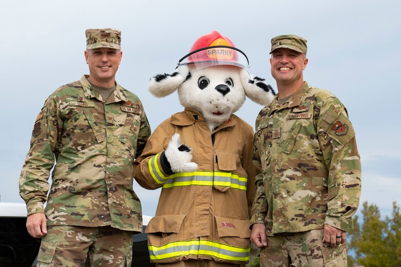 Military children watch the a fire deparptment parade through base housing.