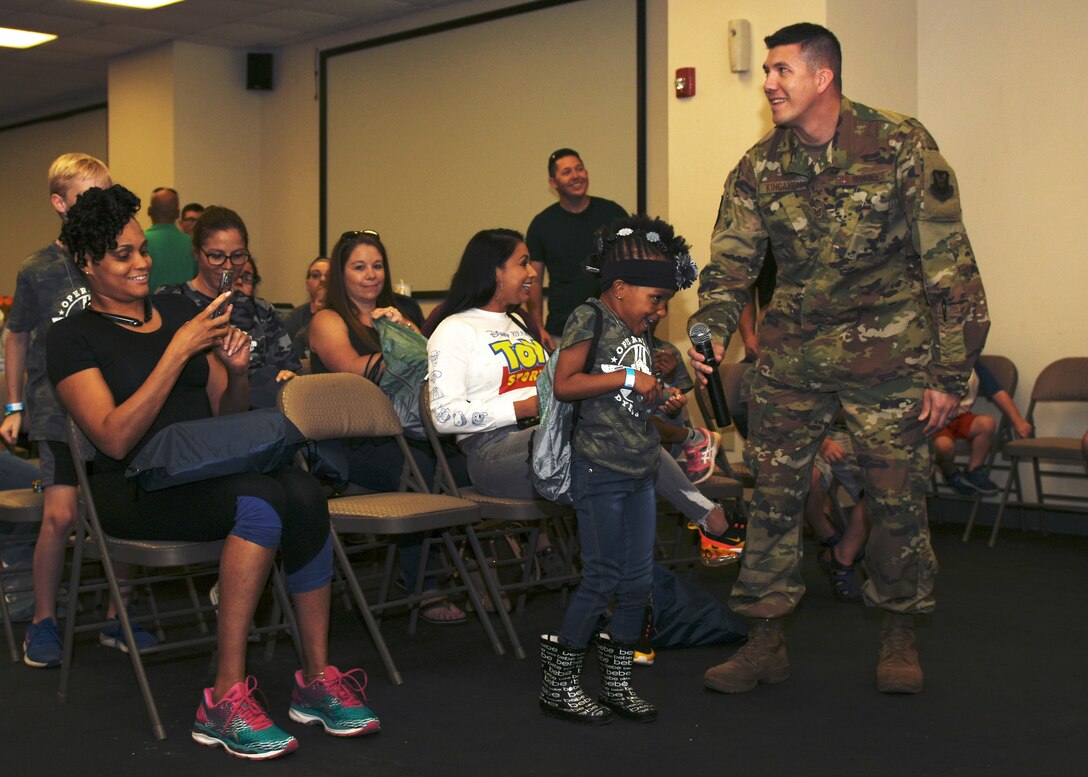 Sapphire Johnson, daughter of Tech. Sgt. Rebecca Johnson, 489th Bomb Group command support staff NCO in charge, calls the room to attention for Col. Ed Sumangil, 7th Bomb Wing commander, during Operation Dyess Kids at Dyess Air Force Base, Texas, Sept. 28, 2019.