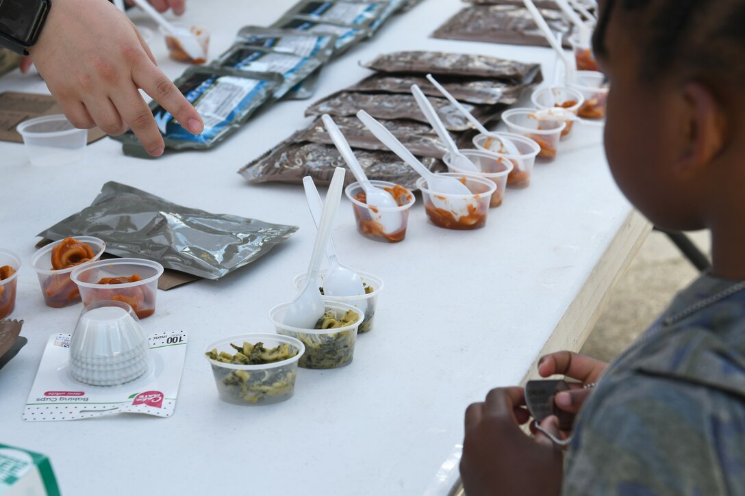 A child tries samples of a Meal, Ready to Eat during Operation Dyess Kids at Dyess Air Force Base, Texas, Sept. 28, 2019.