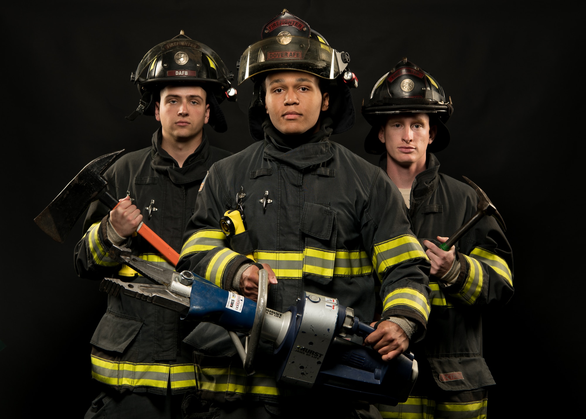 Senior Airman Andrew Frost, Airman 1st Class Dylan Dykes and Senior Airman Patrick Erwin, all 436th Civil Engineer Squadron driver operators, wear their personal protection equipment in honor of Fire Prevention Week Oct. 1, 2019, at Dover Air Force Base, Del. Fire Prevention Week is observed each year in commemoration of the Great Chicago Fire, which began Oct. 8, 1871, and destroyed 2,000 acres of land. (U.S. Air Force photo by Mauricio Campino)