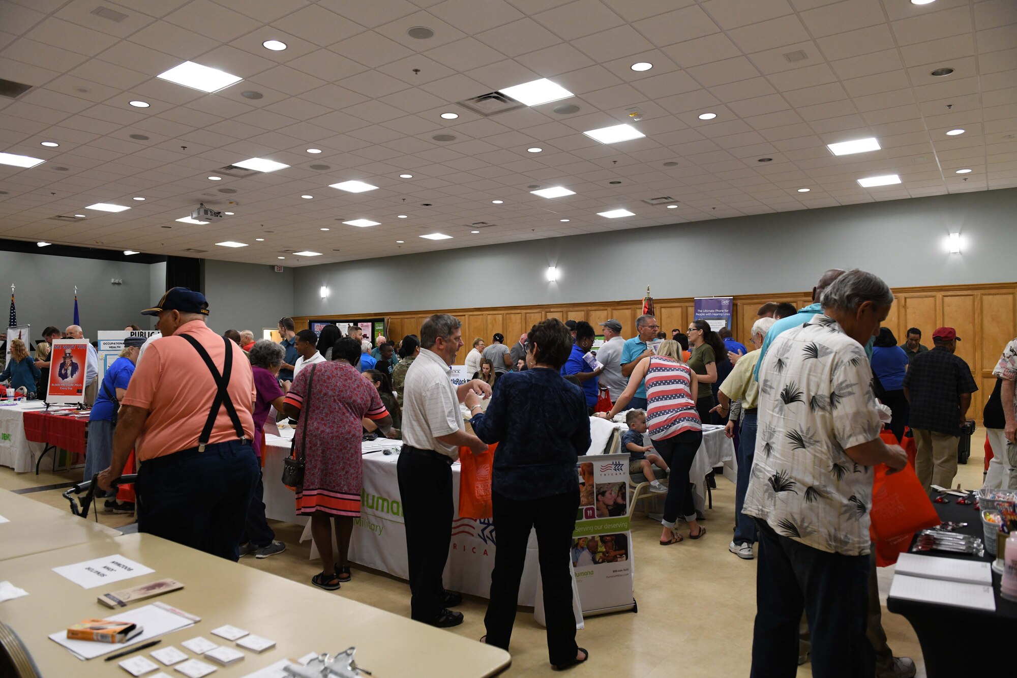 A group walks through information tables