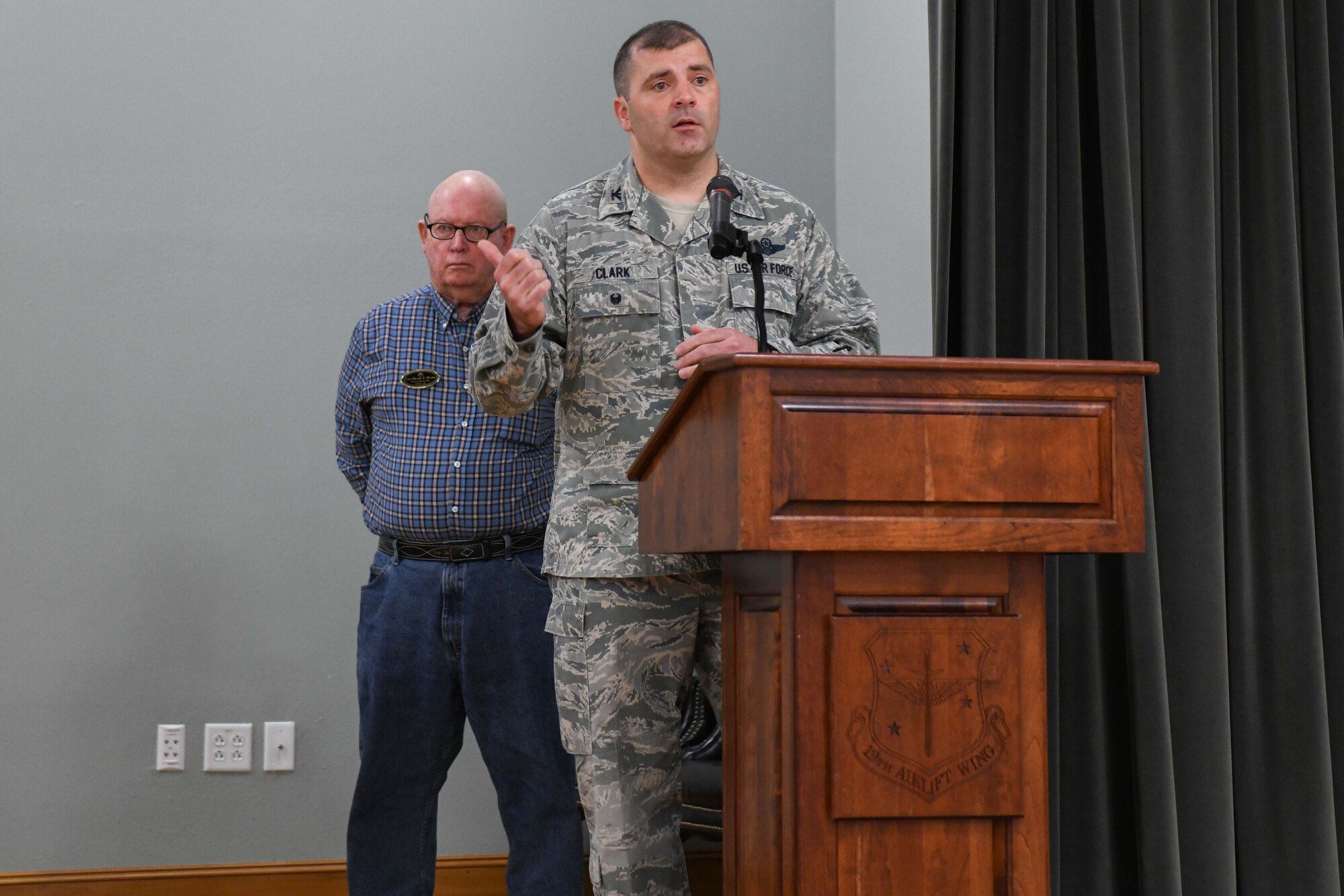 A man speaks at a podium