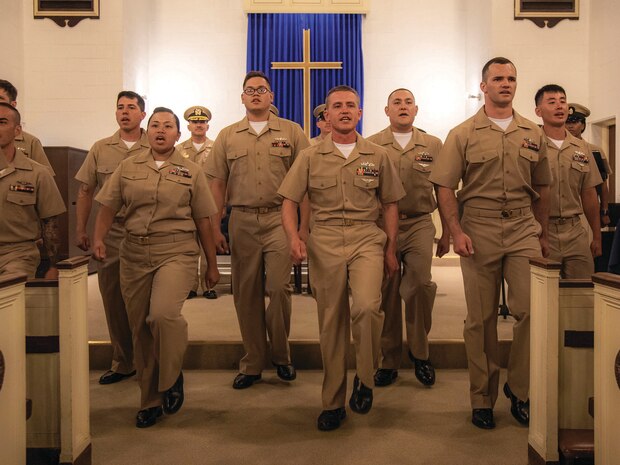 Sailors assigned to Mid-Atlantic Regional Maintenance Center march and sing during a chief petty officer pinning ceremony