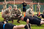 Staff Sgt. Gabriel Wright, a signals intelligence analyst with the 780th Military intelligence Brigade, grades the Hand-Release Push-Up event May 17, 2019, as part of Army Combat Fitness Test Level II Grader validation training, held at Fort Meade, Maryland.