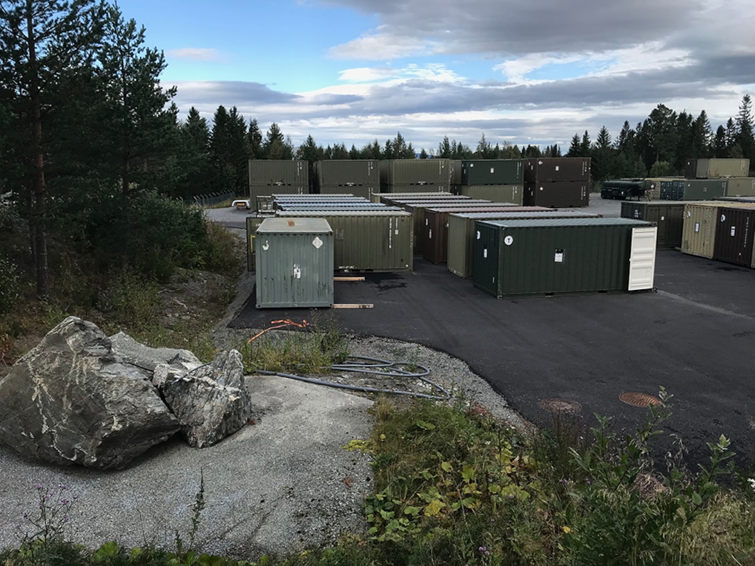 Shipping containers of used, excess and mission-obsolete materials are staged outside a cave facility in Norway, where DLA Disposition Services reps recently visited to help with training and preparation for Marine Corps property disposal.