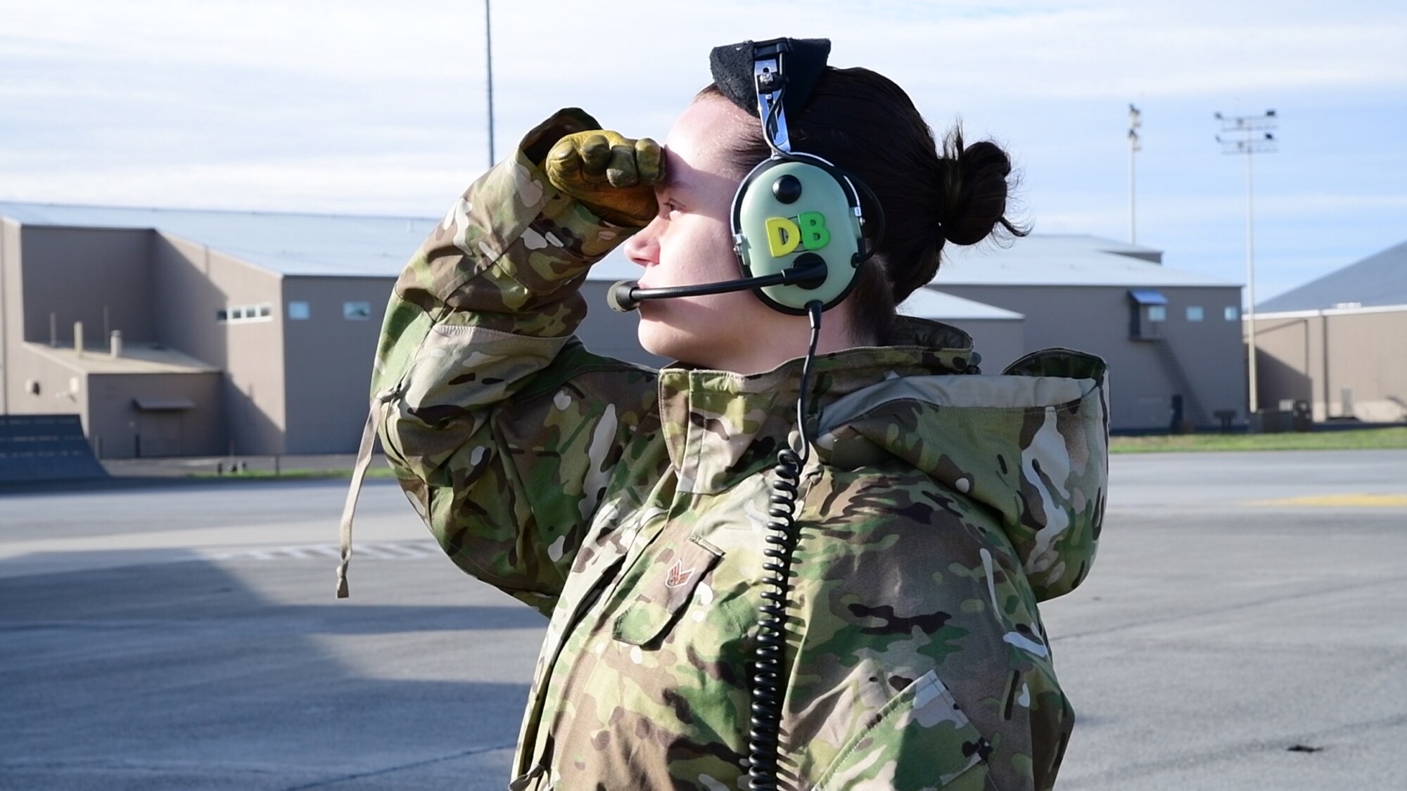 Senior Airman Danele Belovarac, 3rd Airlift Squadron C-17 loadmaster, shields her eyes from the sun while pilots do final pre-flight checks, Sept. 24, 2019, at Fairchild AFB, Wash.,  in support of exercise Mobility Guardian 2019. Exercise Mobility Guardian is Air Mobility Command's premier large-scale mobility exercise. Through robust and relevant training, Mobility Guardian improves the readiness and capabilities of Mobility Airmen to deliver rapid global mobility and builds a more lethal and ready Air Force..(U.S. Air Force photo by Tech. Sgt. Esteban Esquivel).
