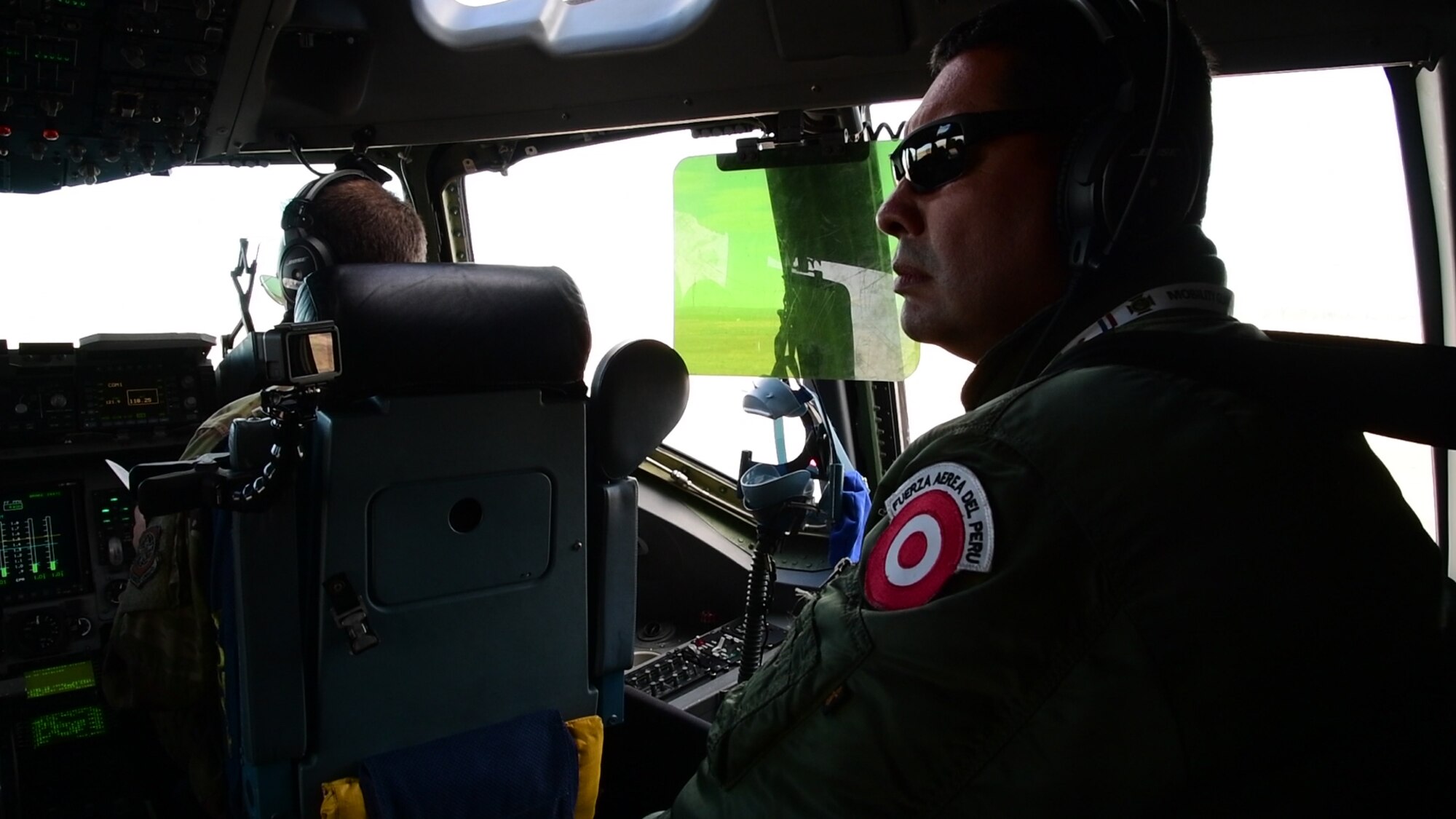 A Peruvian military member looks on as pilots from the 3rd Airlift Squadron fly the C-17 Globemaster III Sept. 23, 2019, at Fairchild AFB, Wash., in support of exercise Mobility Guardian 2019. Exercise Mobility Guardian is Air Mobility Command's premier large-scale mobility exercise. Through robust and relevant training, Mobility Guardian improves the readiness and capabilities of Mobility Airmen to deliver rapid global mobility and builds a more lethal and ready Air Force.(U.S. Air Force photo by Tech. Sgt. Esteban Esquivel).