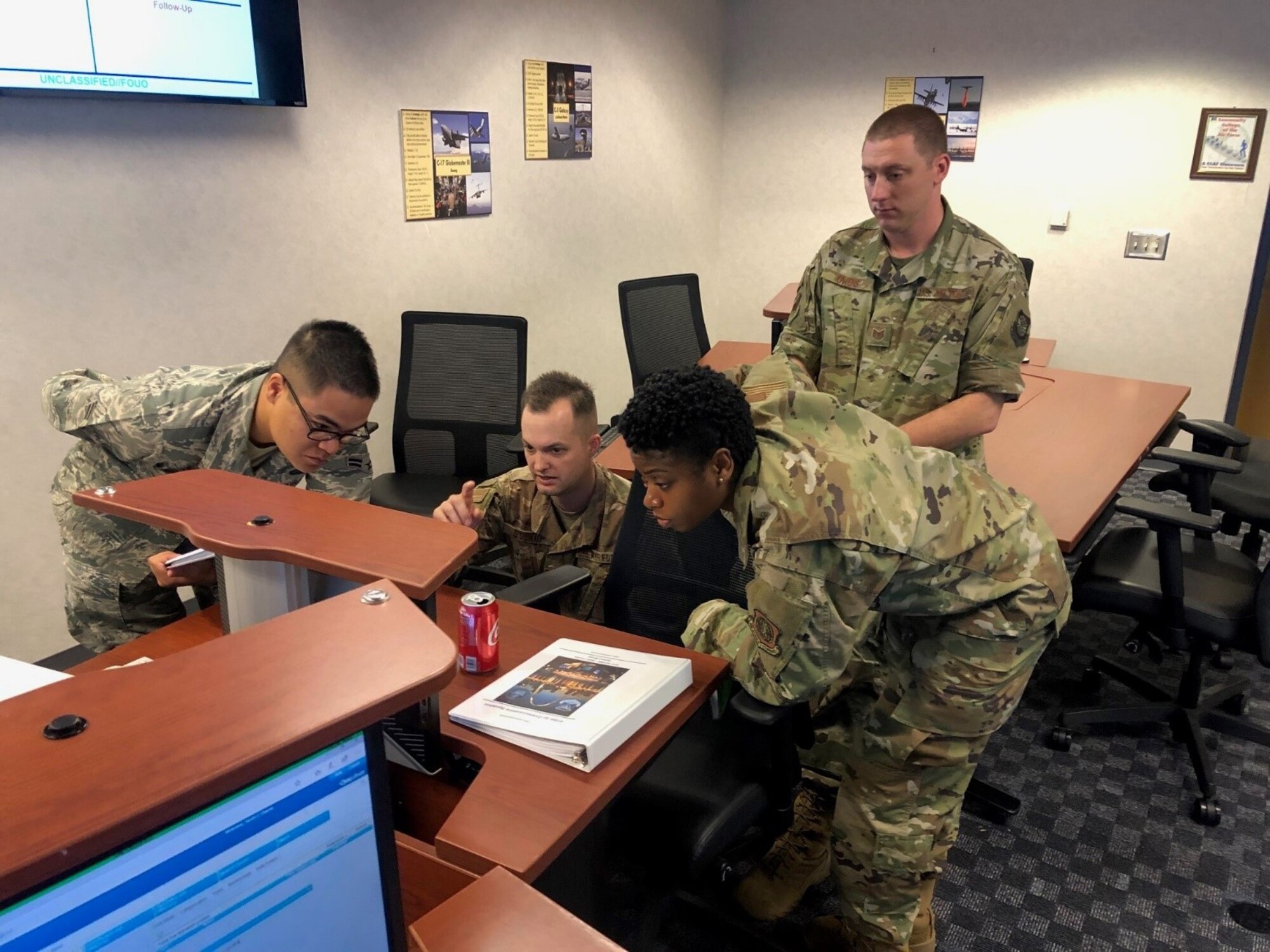 TSgt Kevin Owens, GMAO-Cyber course instructor, observes as students respond to cyber scenarios during AMC’s first Global Mobility Air Operations – Cyber Course (GMAO-Cyber).  The course ensures Cyber Airmen are prepared to support MAF Operations via three distinct phases; Phase I – Understanding your Operating Environment, Phase II – Work Center Responsibilities, and Phase III – CAPSTONE exercises.