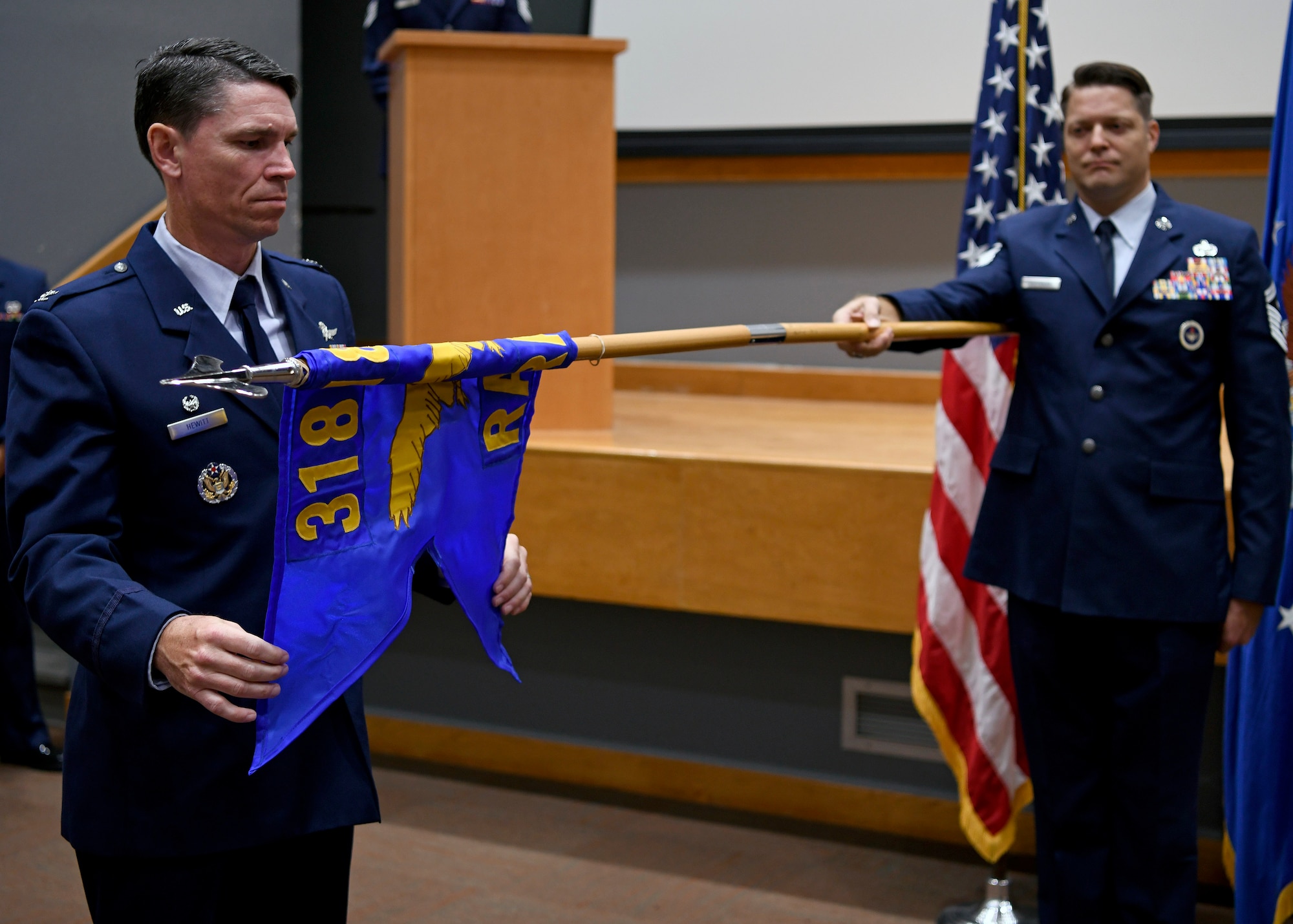 Col. James Hewitt, 318th Cyberspace Operations Group commander, unfurls the 318th Range Squadron guidon flag during the squadron’s activation ceremony at Joint Base San Antonio-Lackland, Texas, Oct. 1, 2019. Lt. Col. Peter Francik also assumed command during the ceremony. (U.S. Air Force photo by Tech. Sgt. R.J. Biermann)