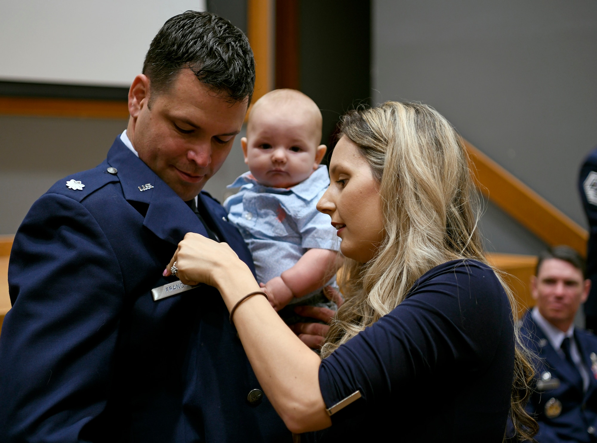 Alexandra Francik pins a commander badge on her husband, Lt. Col. Peter Francik’s uniform, upon assuming command of the 318th Range Squadron during a ceremony at Joint Base San Antonio-Lackland, Texas, Oct. 1, 2019. The 318th RANS was also activated during the ceremony. (U.S. Air Force photo by Tech. Sgt. R.J. Biermann)