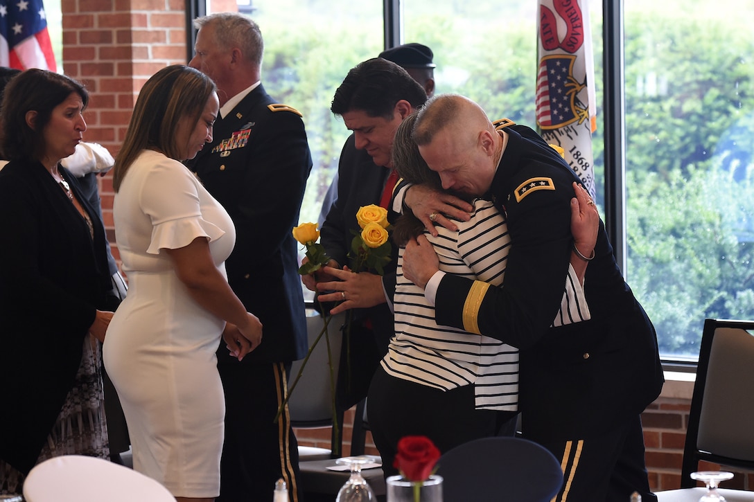 Lt. Gen. Thomas S. James Jr., Commanding General, First U.S. Army, hugs a Gold Star Mother after she received a yellow rose during the Gold Star Mother’s Day luncheon, September 29, 2019, at Cantigny Park in Wheaton, Illinois.