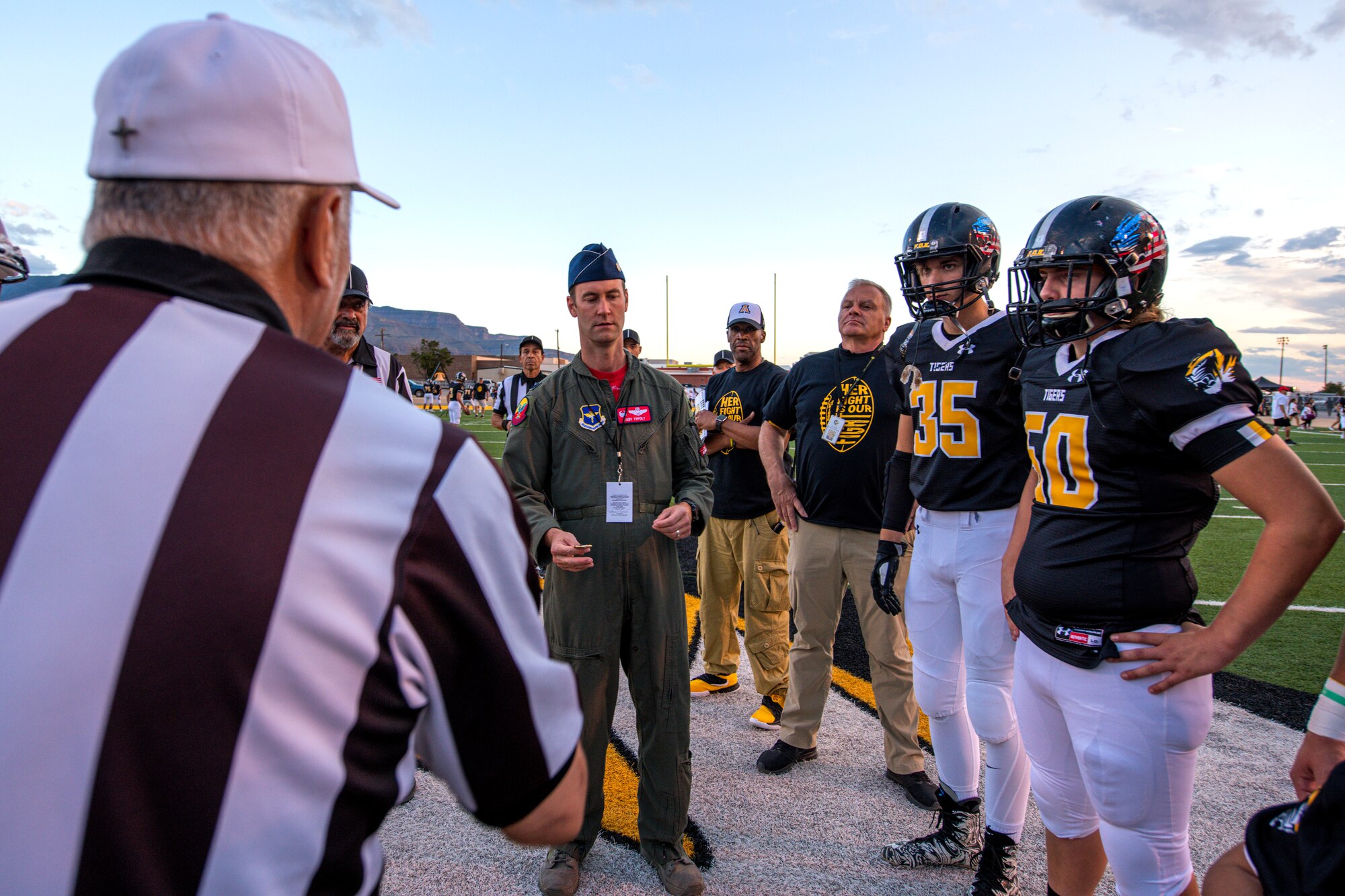 Lt. Col. Ryan Typolt, 29th Attack Squadron commander, prepares to toss a coin prior to an Alamogordo High School Military Appreciation Night football game, Sept. 27th, 2019, in Alamogordo, N.M. Typolt was invited to swear-in nine individuals into the Delayed Entry Program. (U.S. Air Force photo by Staff Sgt. Christine Groening)