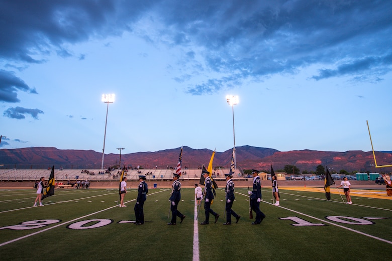 The Alamogordo High School Junior ROTC honor guard posts the colors prior to a AHS Military Appreciation Night football game, Sept. 27th, 2019, in Alamogordo, N.M. Holloman Air Force Base leadership was invited to the event to interact with the local community and enlist nine individuals into the Delayed Entry Program. (U.S Air Force photo by Staff Sgt. Christine Groening)