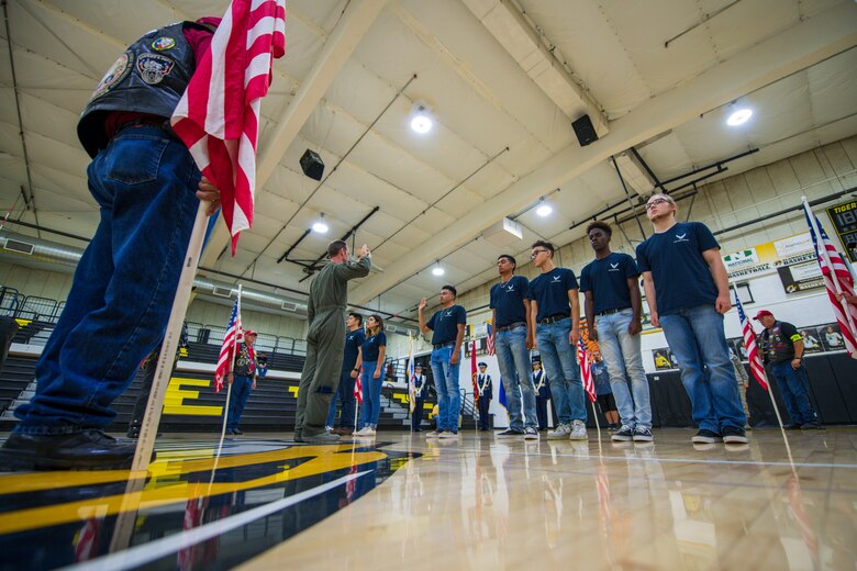 Lt. Col. Ryan Typolt, 29th Attack Squadron commander, recites the Oath of Enlistment to nine Delayed Entry Program enlistees, Sept. 27th, 2019, in Alamogordo, N.M. Patriot Guard Riders held flags around the new enlistees as they swore in. (U.S. Air Force photo by Staff Sgt. Christine Groening)