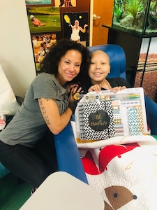 Staff Sgt. Kimberly Gaona, a Texas National Guard Joint Counterdrug Task Force Ground Reconnaissance Detachment operator and a medic with the 149th Medical Group, 149th Fighter Wing, poses with her daughter, Kiyana.