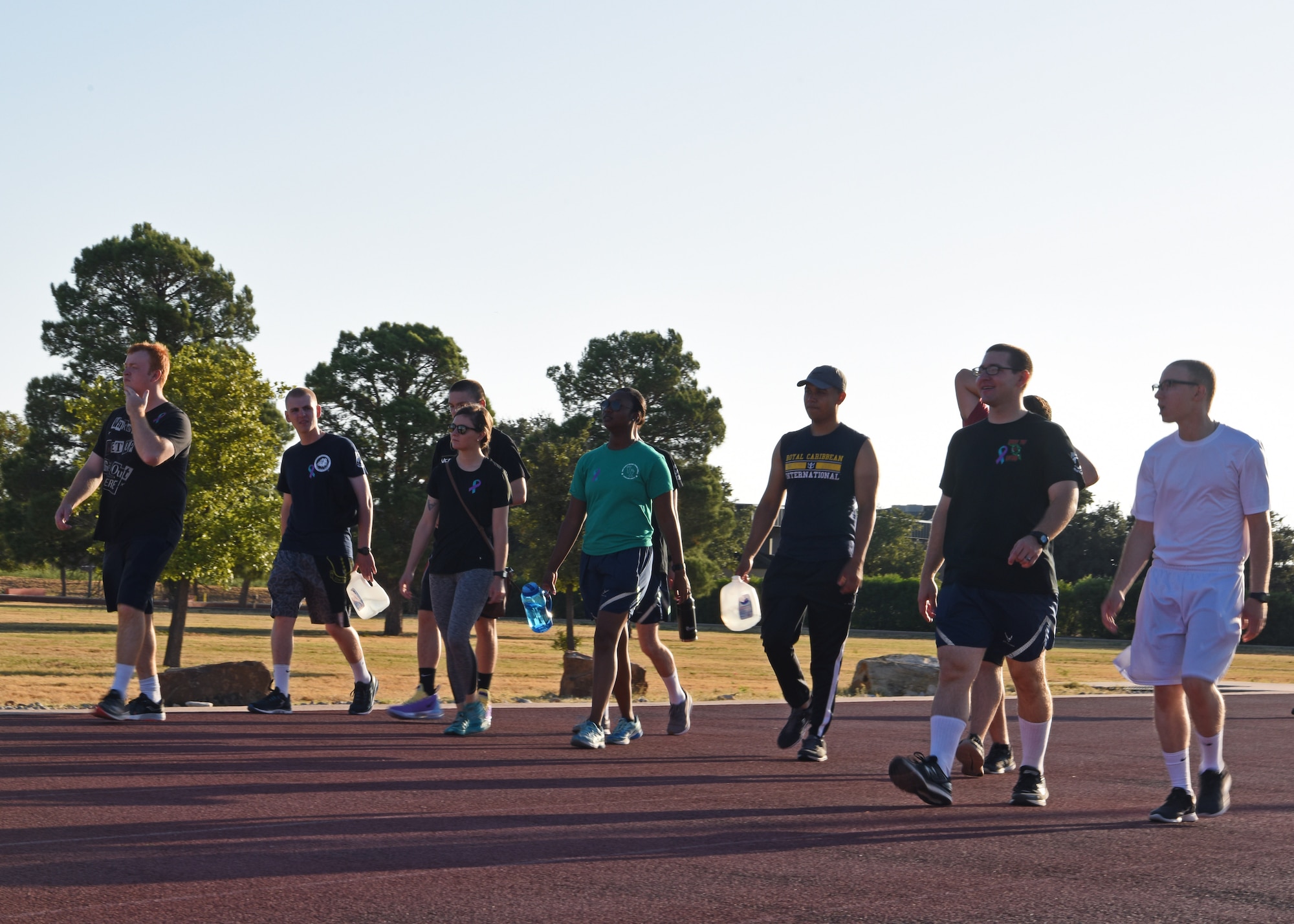 Members of Goodfellow Air Force Base walk side by side as they participate in the 24-Hour Suicide Prevention Run/Walk on Goodfellow Air Force Base, Texas, Sept. 27, 2019. Participating members listened to music and raced around the track in support of suicide prevention. (U.S. Air Force photo by Airman 1st Class Ethan Sherwood/Released)