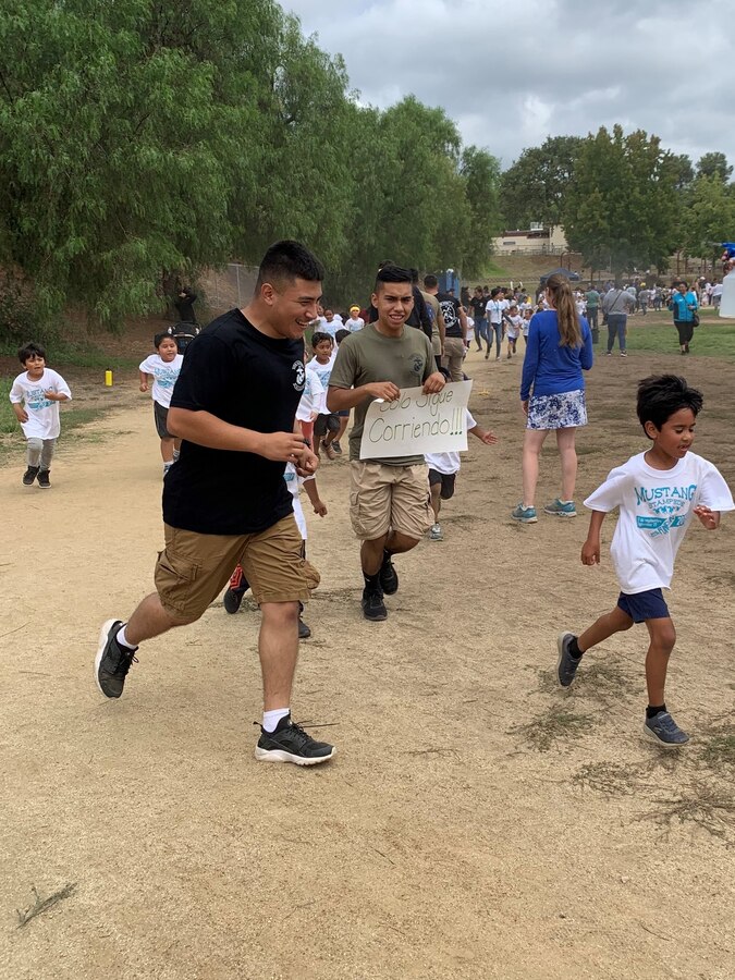 U.S. Marine PFC Smith GamezPinal, left, and LCpl Jomar Ortiz, both

transmissions chiefs from 3rd Low Altitude Air Defense Battalion (LAAD), 3rd

Marine Aircraft Wing (MAW) run with and encourage children from Maie Ellis

Elementary in Fallbook, Calif., Sept. 27. Marines paced the students around

the track and showed them the importance of maintaining a "never quit"

attitude.  More than 500 students ran laps as part of the school's

fundraising efforts toward reading programs and after-school activities.

Marines from 3rd MAW always take great pride in interacting with and

supporting the local community. (U.S. Marine Corps photo courtesy of 3rd Low

Altitude Air Defense Battalion)