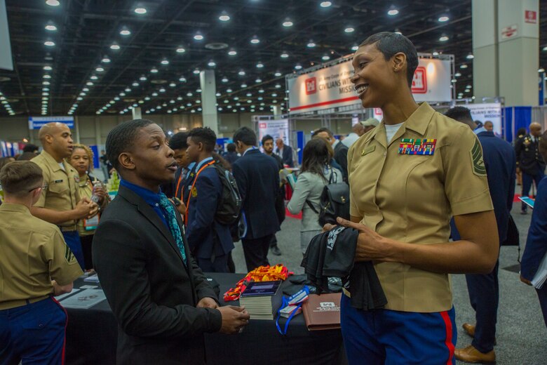 Claude King, a senior at Hampton University, discuss career opportunities with Gunnery Sgt. Latyra Sayers, a career recruiter with Recruiting Station San Diego, during a National Society of Black Engineers conference career fair in Detroit, Michigan, March 28. NSBE is holding its 45th annual national convention consisting of various programs and workshops that are designed to benefit grade school, collegiate, technical, professional and international attendees and the U.S. Marine Corps is a partner organization. Marines partner with organizations like NSBE to ensure its message of opportunity reaches diverse audiences. (U.S. Marine Corps photo by Lance Cpl. Mitchell Collyer)