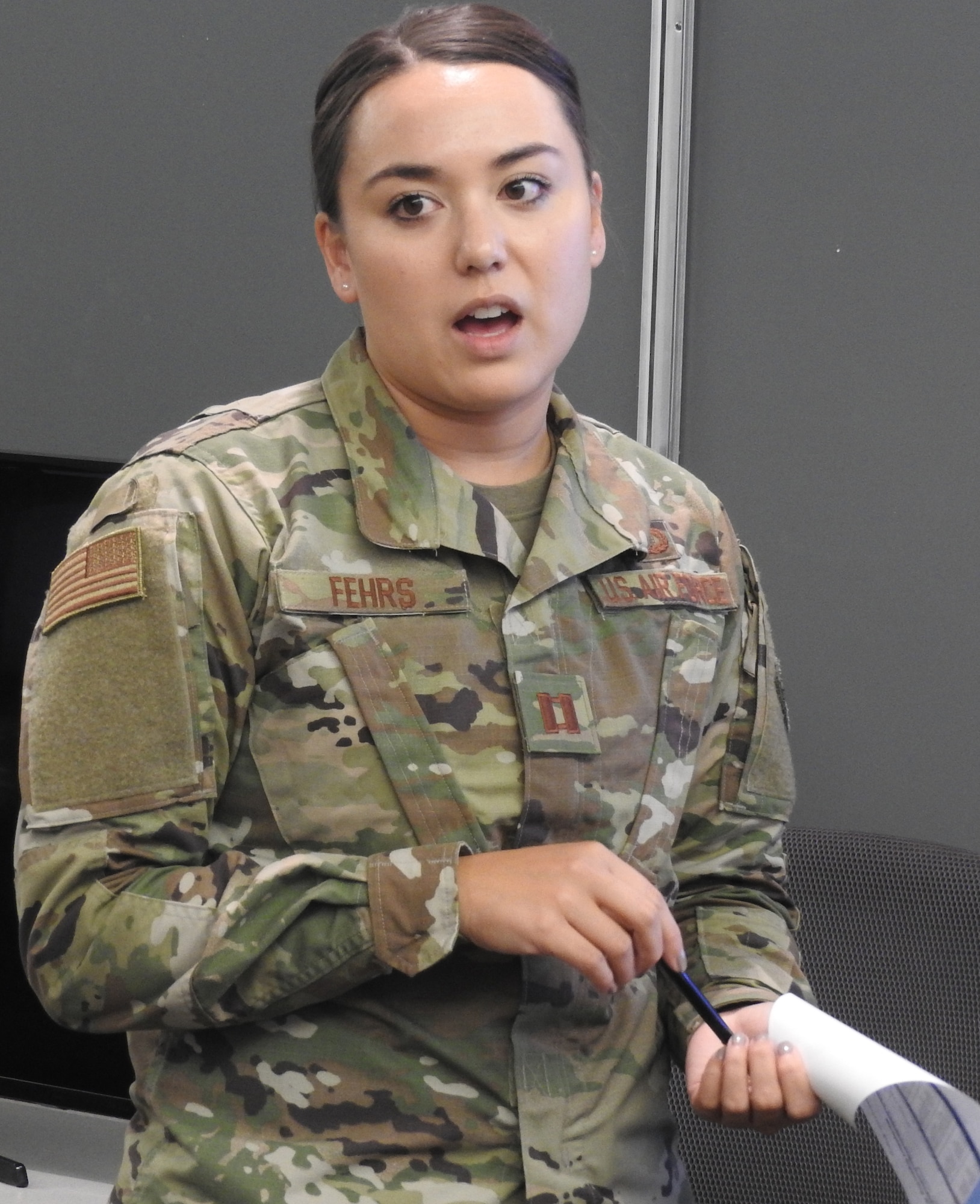 Budget analysts in the AFIMSC war room provided daily updates on the status of end-of-fiscal year activities. Capt. Mary Fehrs, AFIMSC budget analyst, discusses closeout actions by installations in the Pacific. (Air Force photo by Ed Shannon)