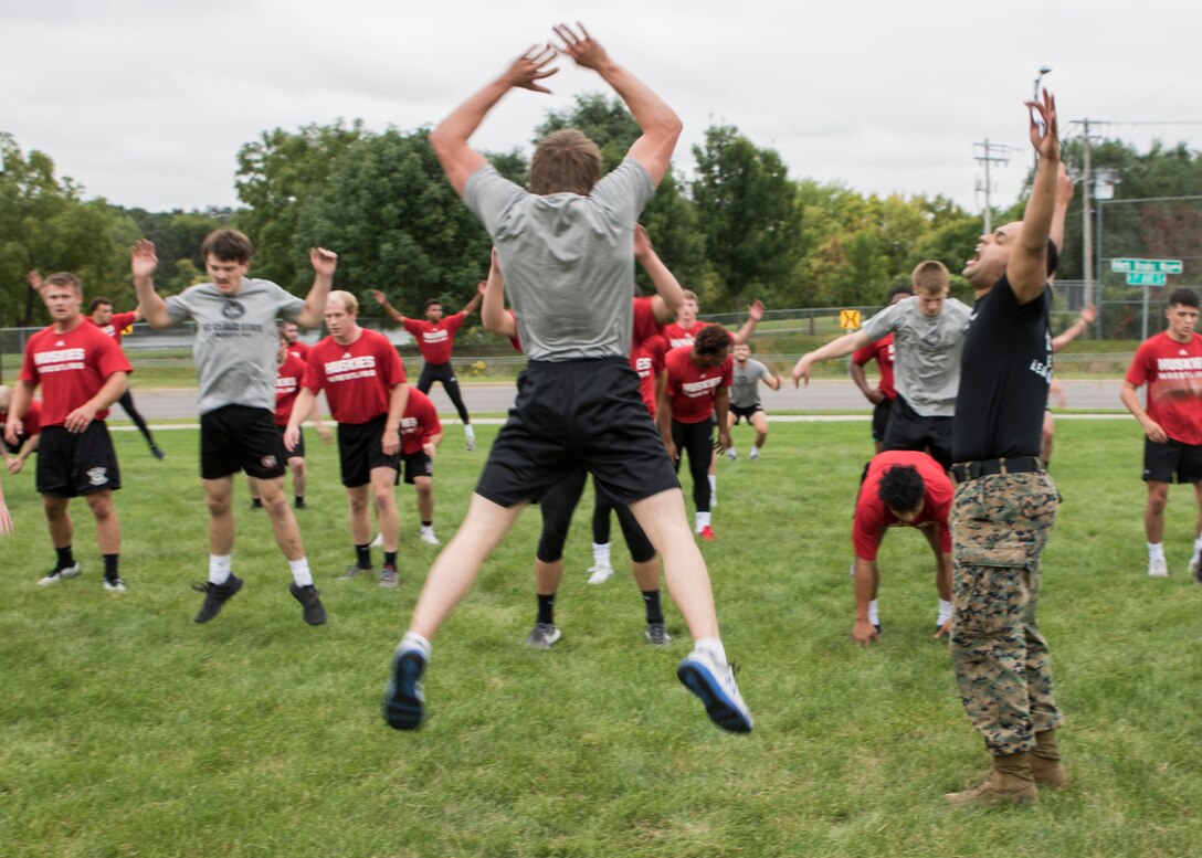 ST. CLOUD, Minn. -- The Marine Corps Officer Selection Team from Fargo, North Dakota, pushes the St. Cloud State University Wrestling team through a Leadership and Cohesion Exercise designed to test their physical and mental strength, as well as their ability to work as team, in St. Cloud, M.N., Sept. 18, 2018. At the end of the exercises, the Marines lead the team through a discussion about their core values; honor, courage and commitment, and how the athletes can apply those values to what they do as wrestlers, but also as students and ambassadors for the university.