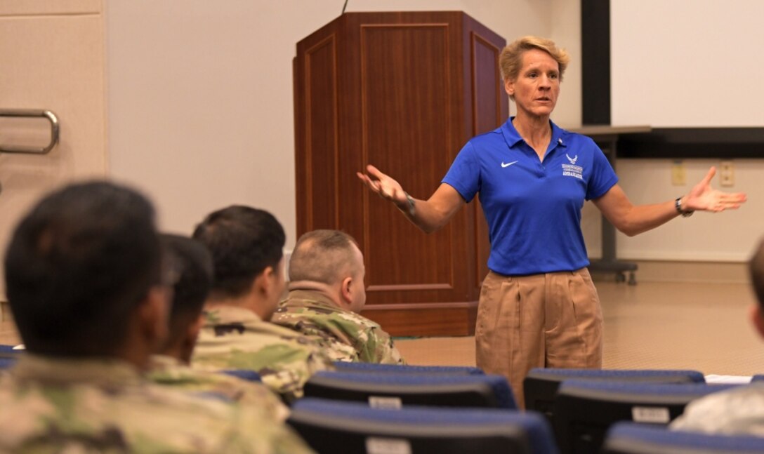 U.S. Air Force Col. (ret) Laurel “Buff” Burkel addresses the audience during her presentation for the Air Force element resiliency stand down Sept. 27, 2019, at U.S. Forces Korea Headquarters on Camp Humphreys, South Korea. Throughout her address, Burkel includes photos of of her rehabilitation after her neck was broken in a helicopter crash in Afghanistan. (U.S. Army photo by Sgt. Austin Fox/Released)