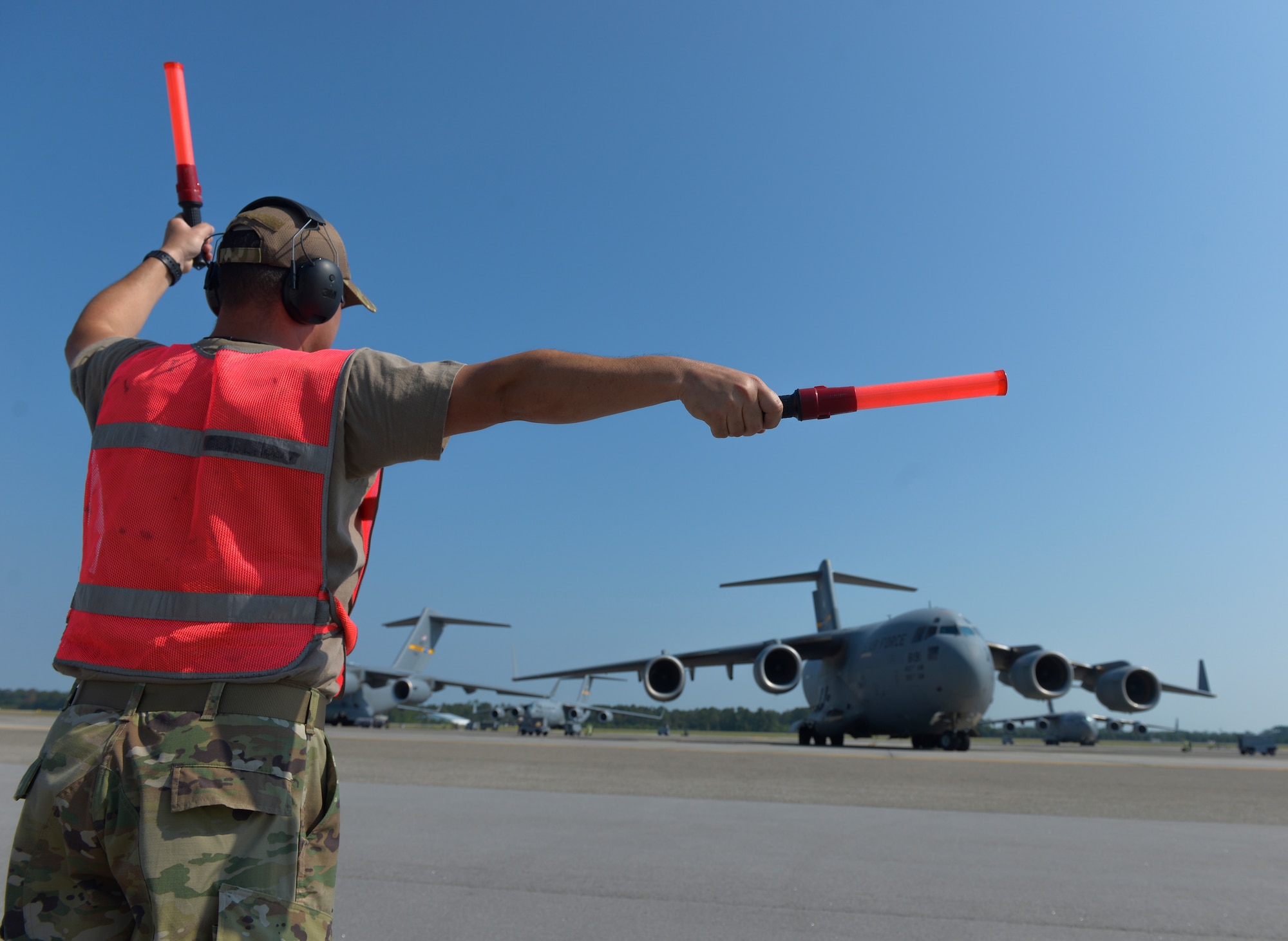 U.S. Air Force Master Sgt. Jeffery Smith, an aircraft maintenance technician assigned to the 315th Aircraft Maintenance Squadron, marshals a C-17 Globemaster III before a local training flight at Joint Base Charleston, S.C., Sept. 30, 2019. The general duties of an aircraft maintenance technician is to perform daily maintenance, diagnose malfunctions, replace components and perform crash recovery. After their initial training, Airmen may be assigned to specialize in the maintenance of specific aircraft.