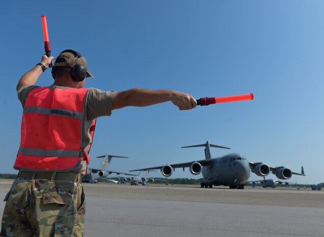 U.S. Air Force Master Sgt. Jeffery Smith, an aircraft maintenance technician assigned to the 315th Aircraft Maintenance Squadron, marshals a C-17 Globemaster III before a local training flight at Joint Base Charleston, S.C., Sept. 30, 2019. The general duties of an aircraft maintenance technician is to perform daily maintenance, diagnose malfunctions, replace components and perform crash recovery. After their initial training, Airmen may be assigned to specialize in the maintenance of specific aircraft.