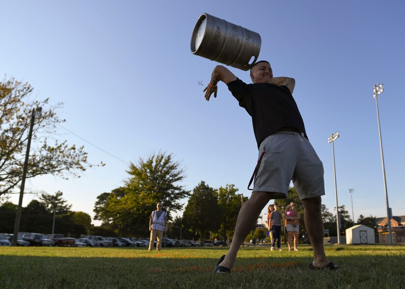 An event attendee tosses a keg during an Oktoberfest celebration at Joint Base Langley-Eustis, Virginia, Sept. 27, 2019.