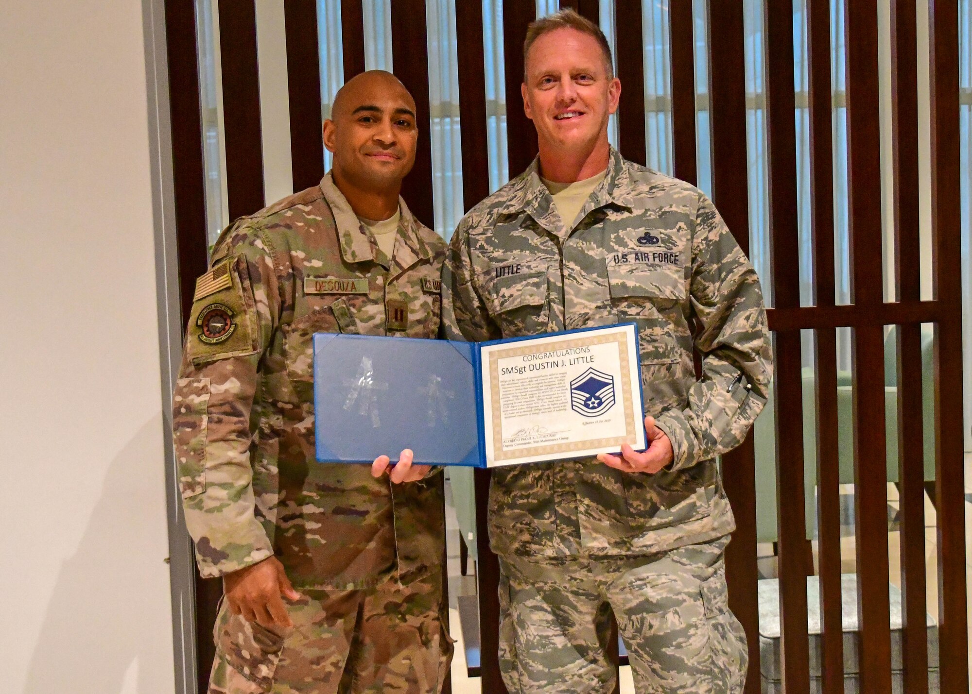 Senior Master Sgt. D.J. Little, 94th Maintenance Squadron hydraulics technician, right, poses with Capt. Sean DeSouza, at his promotion ceremony in Portugal on Sept. 30, 2019. Little was STEP promoted to the rank of senior master sergeant while TDY in support of Exercise Real Thaw. (U.S. Air Force photo/Senior Airman Justin Clayvon)