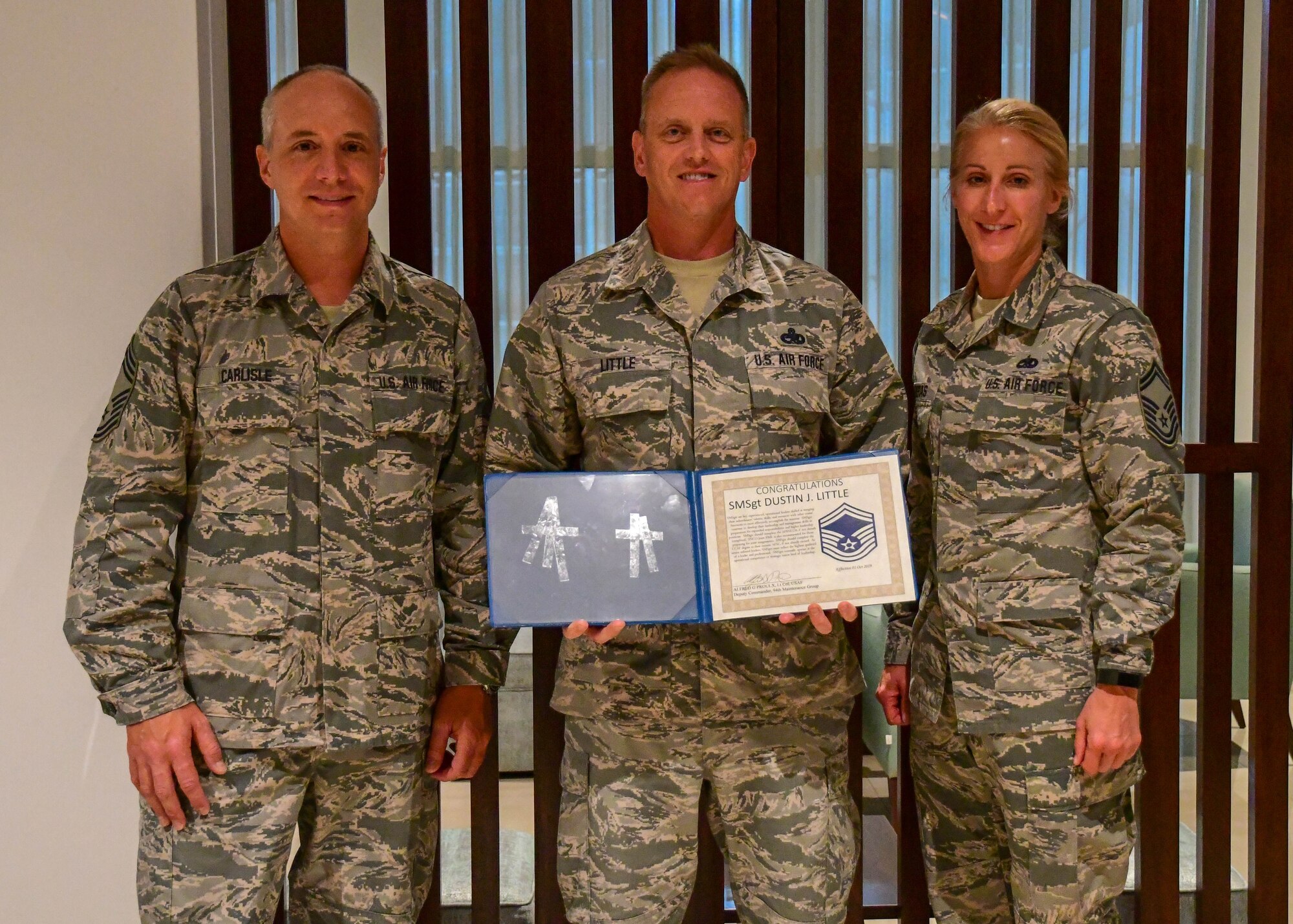 Senior Master Sgt. D.J. Little, 94th Maintenance Squadron hydraulics technician, center, poses with Chief Master Sgt. Mark Carlisle and Senior Master Sgt. Karie Contreras at his promotion ceremony in Portugal on Sept. 30, 2019. Little was STEP promoted to the rank of senior master sergeant while TDY in support of Exercise Real Thaw. (U.S. Air Force photo/Senior Airman Justin Clayvon)