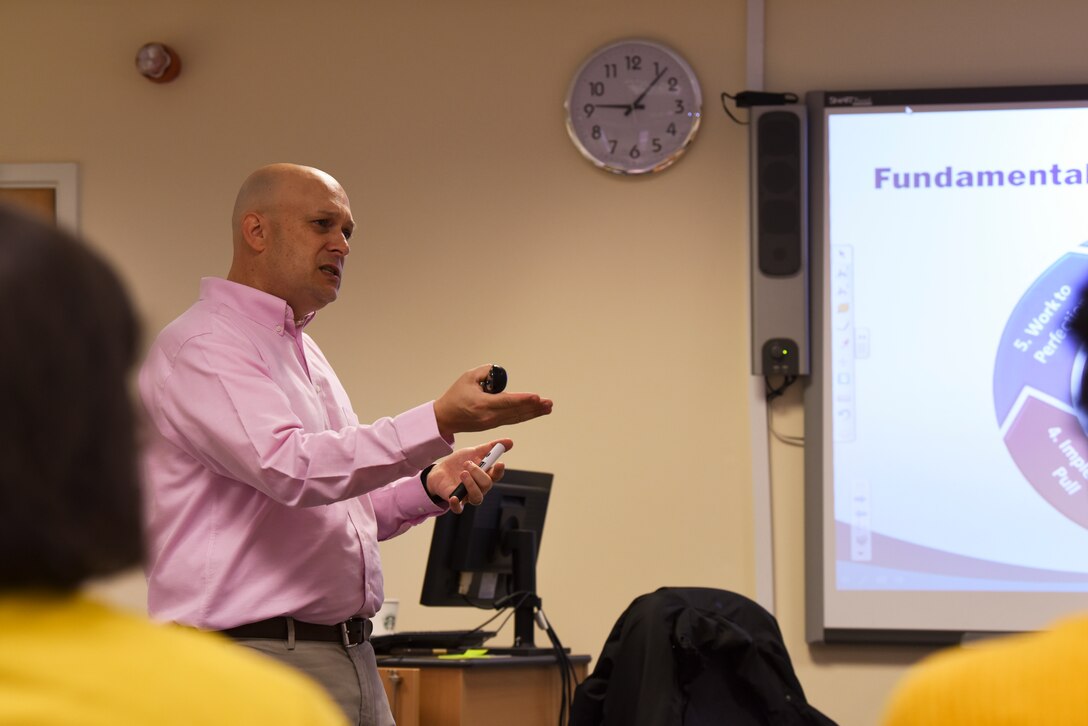 Senior Master Sgt. Stephen Holdenreid, 100th Air Refueling Wing continuous process improvement manager, discusses the fundamentals, principles and wastes during a continuous process improvement seminar at RAF Mildenhall, Sept. 26, 2019. The CPI seminar was to inform spouses on key principles of lean, Six Sigma method and business process reengineering. (U.S. Air Force photo by Staff Sgt. Matthew J. Wisher)