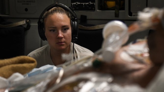 Capt. Natasha Cardinal, 86th Aeromedical Evacuation Squadron critical care nurse, monitors her patient during a flight from Bagram Airfield, Afghanistan to San Antonio, Texas, Aug. 18, 2019. Critical care air transport teams are rapidly deployable teams consisting of a physician, critical care nurse and a respiratory therapist who provide a mobile intensive care unit for complex, critically wounded patients. (U.S. Air Force photo by Airman 1st Class Ryan Mancuso)