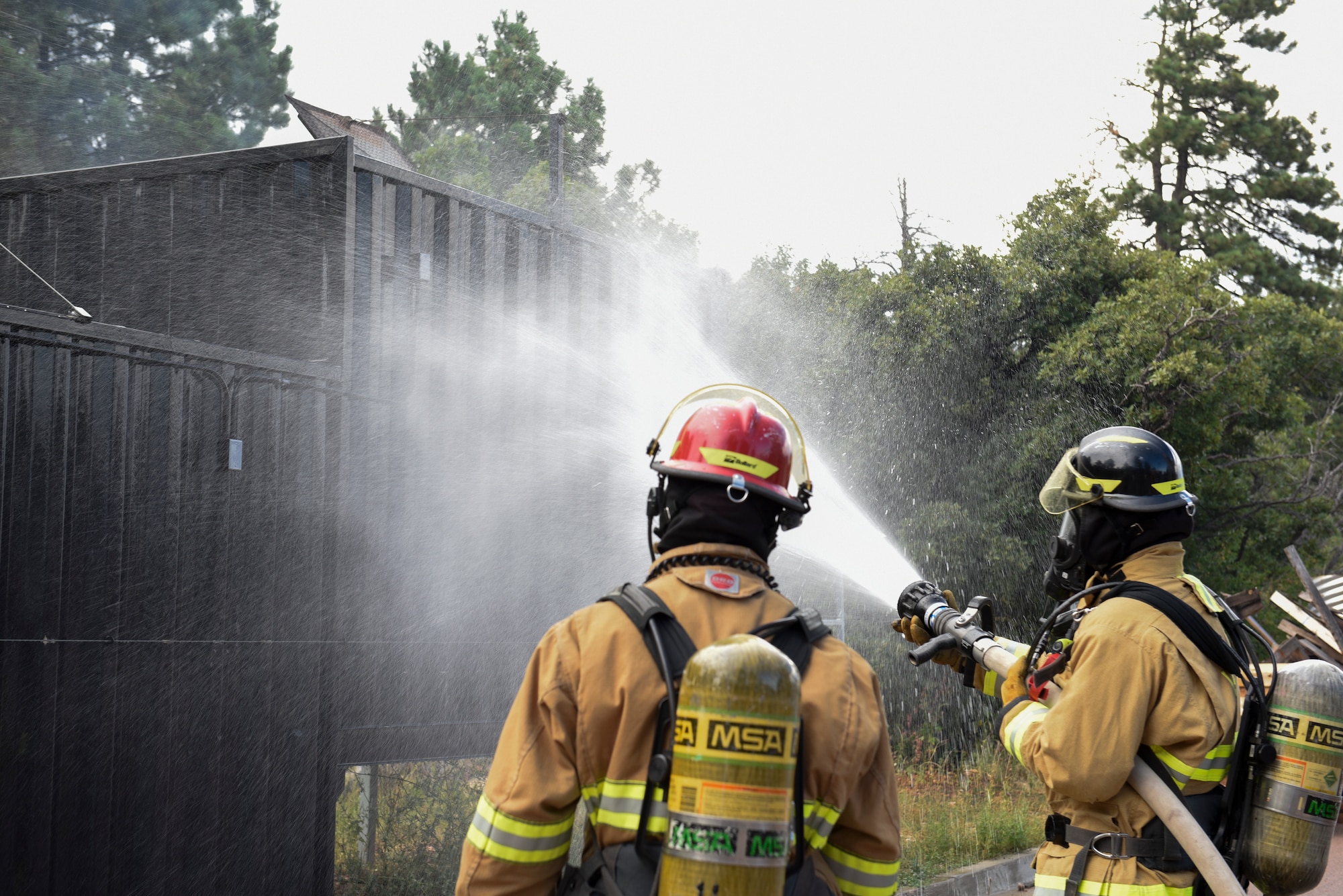 Firefighters at Cheyenne Mountain Air Force Station, Colorado, train in order to fight fires in a variety of settings, Sept. 6, 2019. Their duty station includes 560 acres of forested land and the massive Cheyenne Mountain Complex underneath Cheyenne Mountain. (U.S. Air Force photo by Airman Alexis Christian)