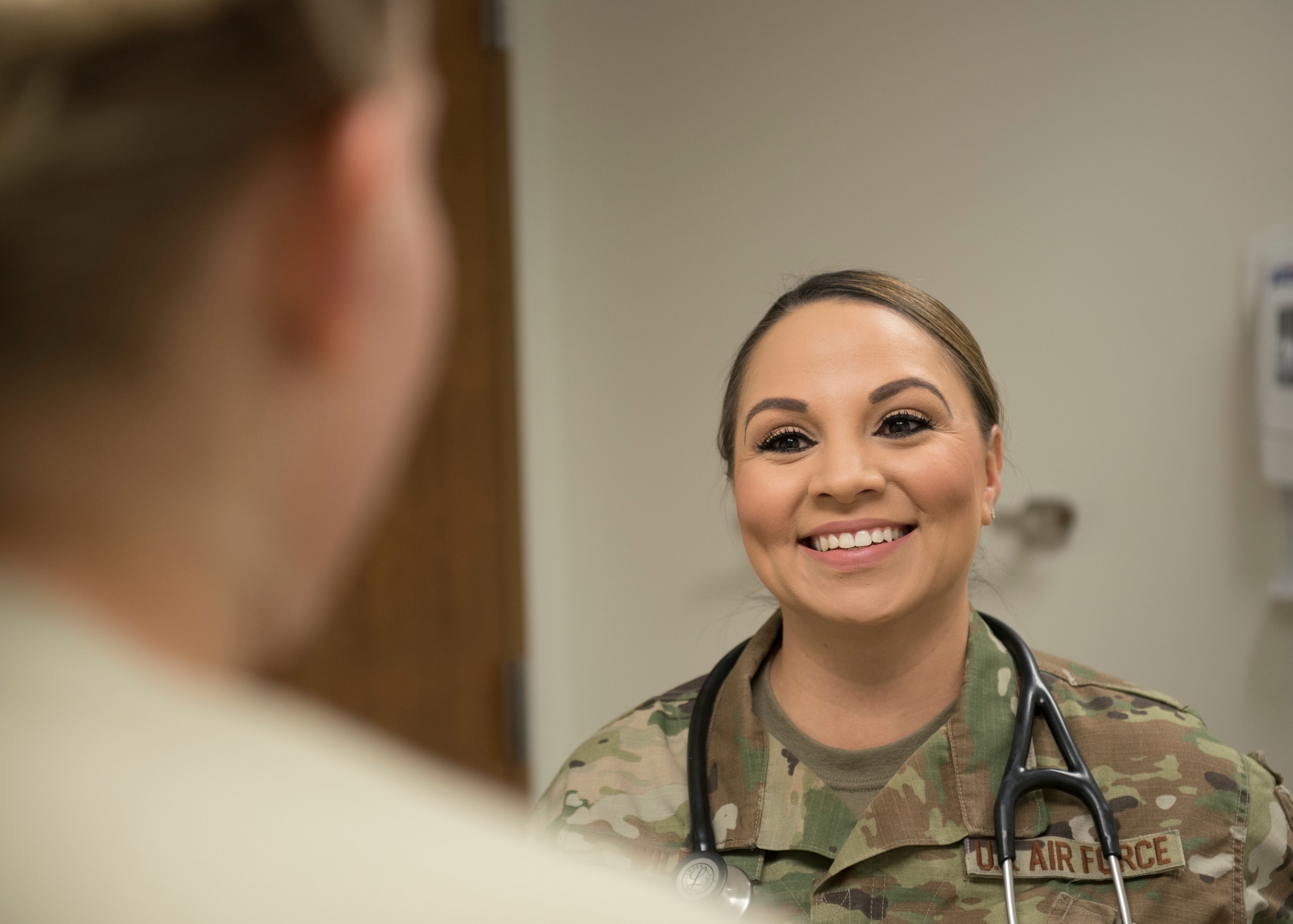 Tech. Sgt. Jerrica Wild, 21st Operational Medical Readiness Squadron independent duty medical technician, speaks to a patient at the clinic on Peterson Air Force Base, Colorado, September 25, 2019. Wild is also stationed at Cheyenne Mountain Air Force Station and provides care to the personnel there, alleviating the pressure of manning resources by patients not having to travel. (U.S. Air Force photo by Airman Alexis Christian)