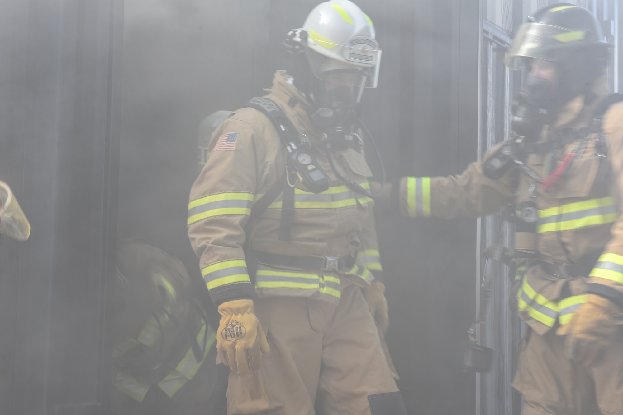 Col. Thomas Falzarano, 21st Space Wing commander walks out of the fire training area at Cheyenne Mountain Air Force Station, Colorado, Sept. 6, 2019 after participating in a training exercise with the Fire Department located at the Mountain. Training exercises like this help train the fire fighters how to anticipate how fire will react under certain conditions. (U.S. Air Force photo by Airman Alexis Christian)