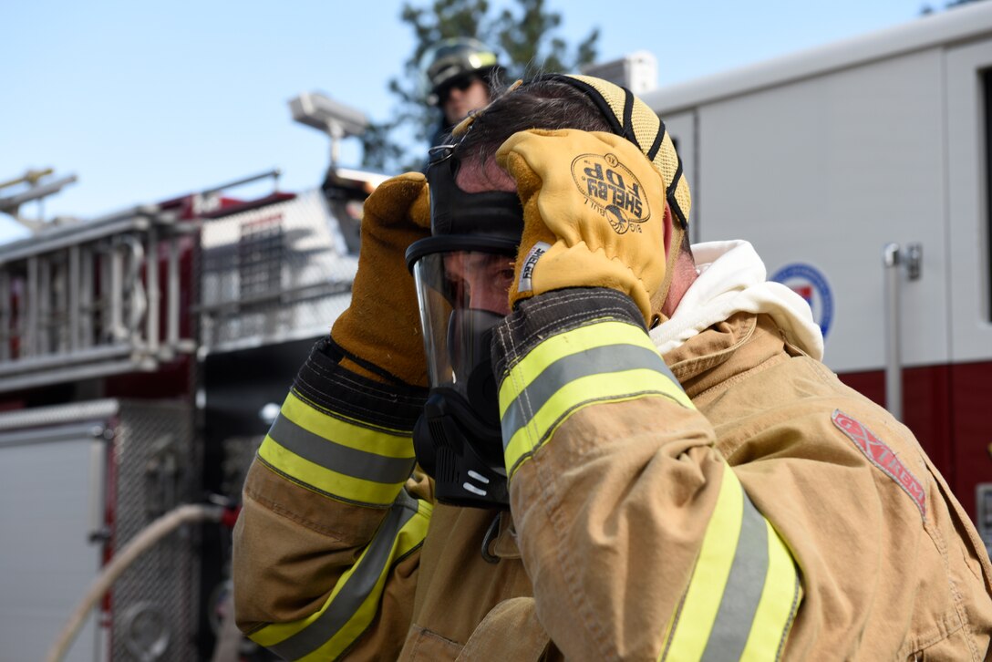 Col. Thomas Falzarano, 21st Space Wing commander, prepares to take off the fire gear used during the training exercise he took part in sept. 6, 2019 at Cheyenne Mountain Air Force Station, Colorado. Falzarano had the chance to participate in the training exercise to see how the Airman there train for their particular mission. (u.S. Air Force photo by Airman Alexis Christian)