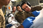 A critical care air transport team tends to a patient during a nearly 20-hour direct flight from Bagram Airfield, Afghanistan, to San Antonio on Aug. 18, 2019. The service member was cared for by a joint service team of extracorporeal membrane oxygenation specialists, an aeromedical evacuation team and a CCATT in order to maintain the highest level of care possible during transport.