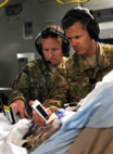 Lt. Col. Valerie Sams, 59th Medical Wing trauma surgeon, and Lt. Col. Scott King, 86th Aeromedical Evacuation Squadron critical care air transport team physician, perform an ultrasound on a critically wounded service member during a flight from Bagram Airfield, Afghanistan, to San Antonio on Aug. 18, 2019. The service member suffered extensive wounds during combat operations that required constant monitoring over the duration of a nearly 20-hour direct flight from Afghanistan to Texas.