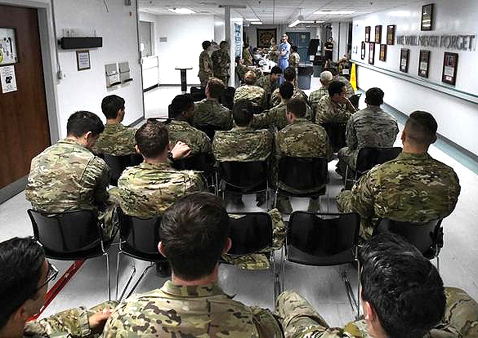 Service members wait in line to donate blood at Craig Joint Theater Hospital at Bagram Airfield, Afghanistan, Aug. 18, 2019, as part of a "walking blood bank" for a fellow service member being transferred to Brooke Army Medical Center in San Antonio. A request for volunteers with a specific blood type was filled within minutes, providing fresh whole blood to sustain the patient during the lengthy flight home.